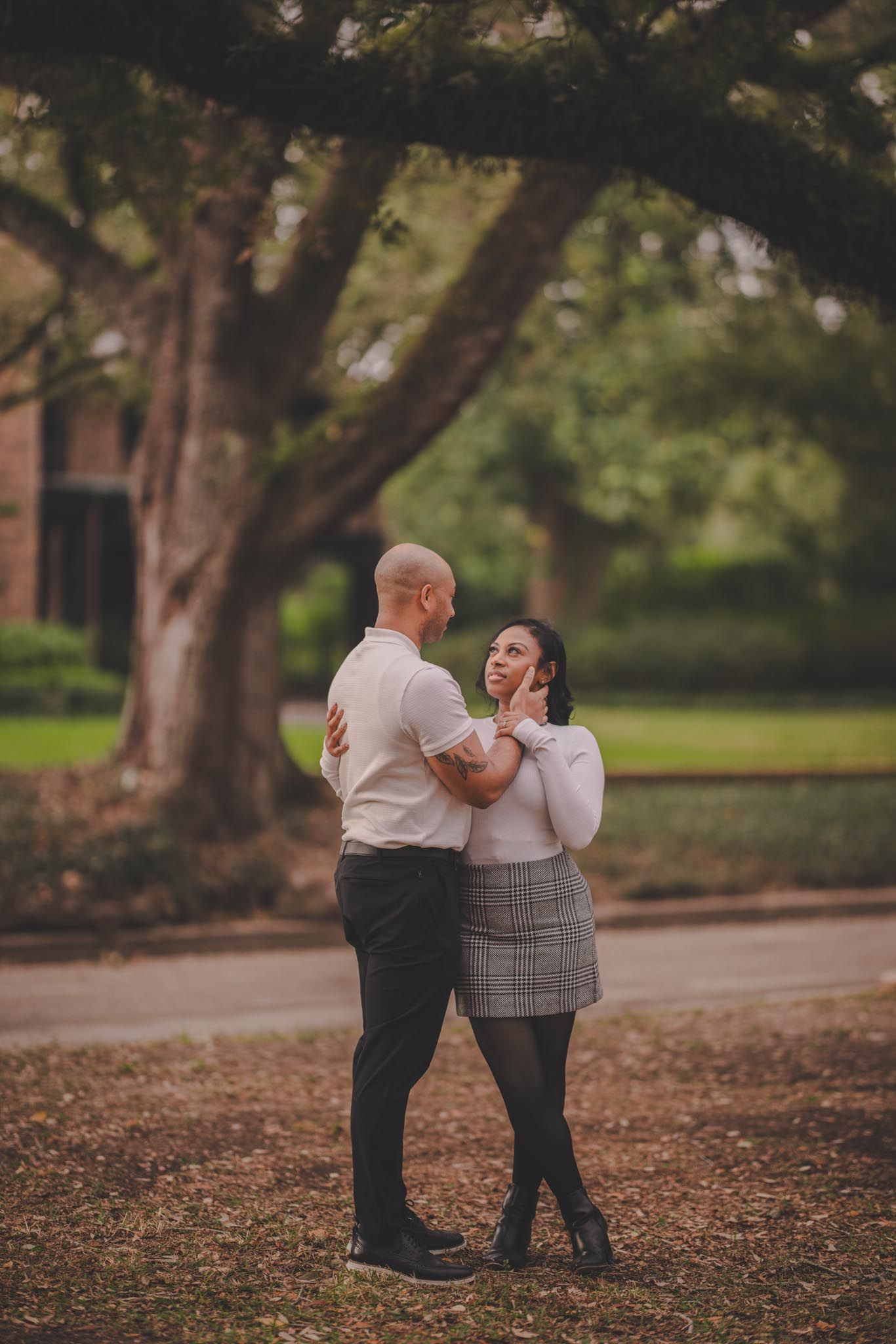 Romantic couple sharing tender moment while walking through autumn park.
