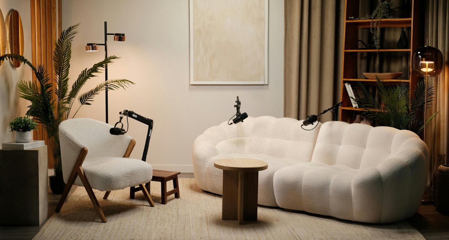 Modern minimalist interior with white curved sofa and contemporary furniture pieces.