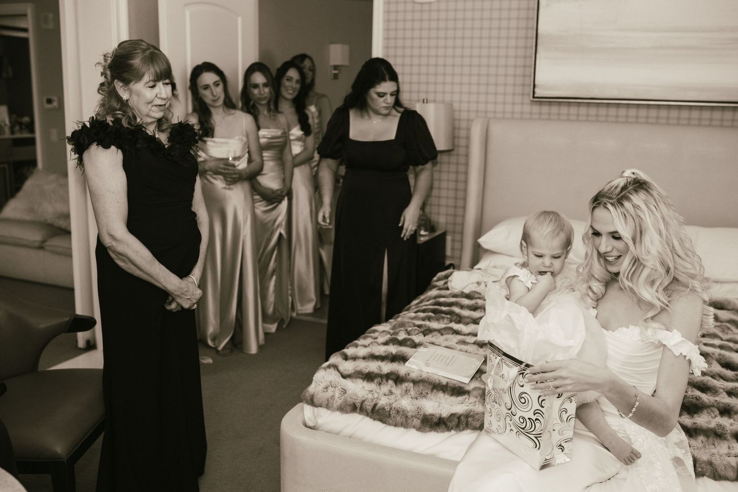 Wedding preparations in progress with attendants helping in a bright indoor setting.