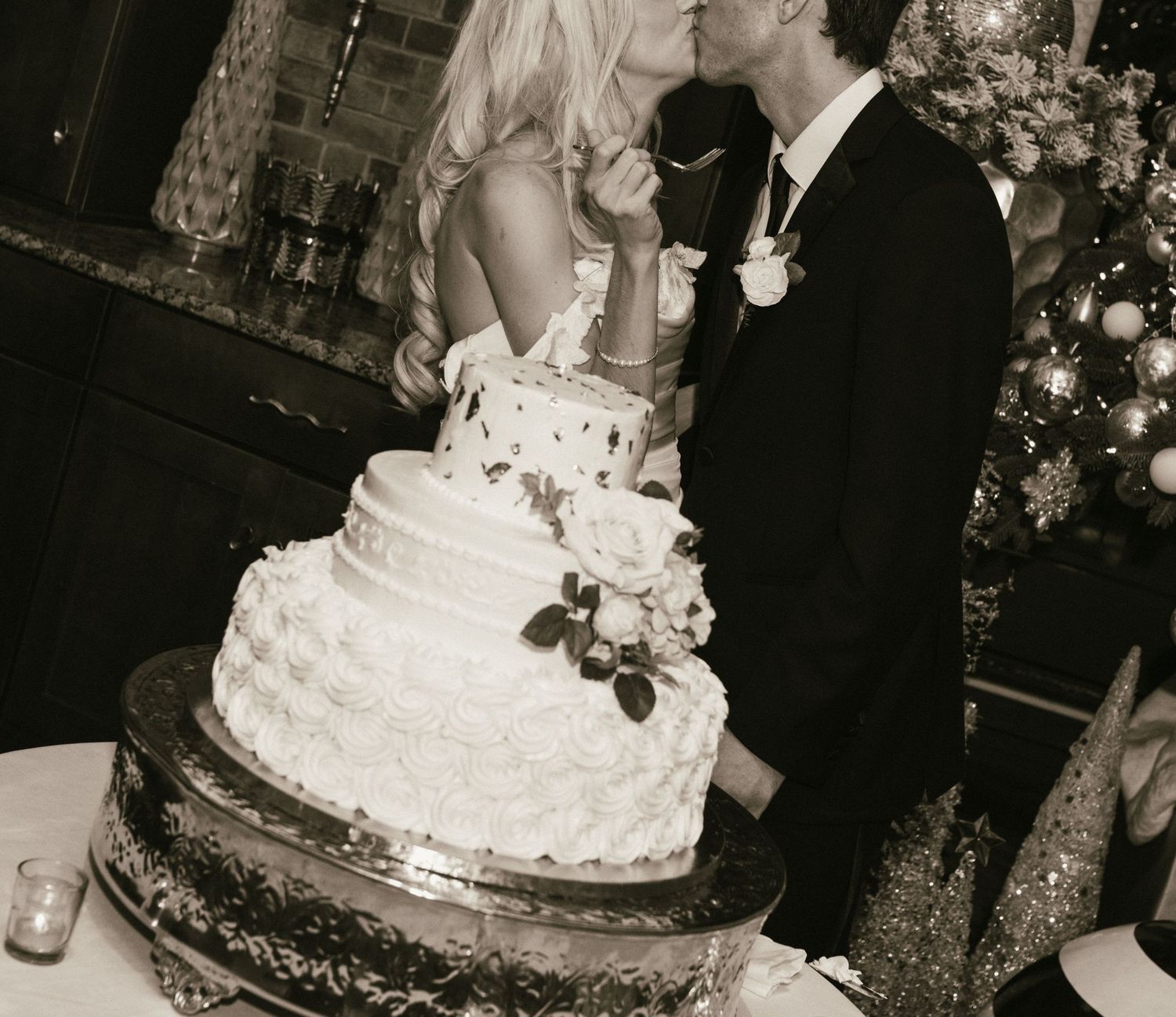 Wedding cake cutting moment at an elegantly decorated reception.