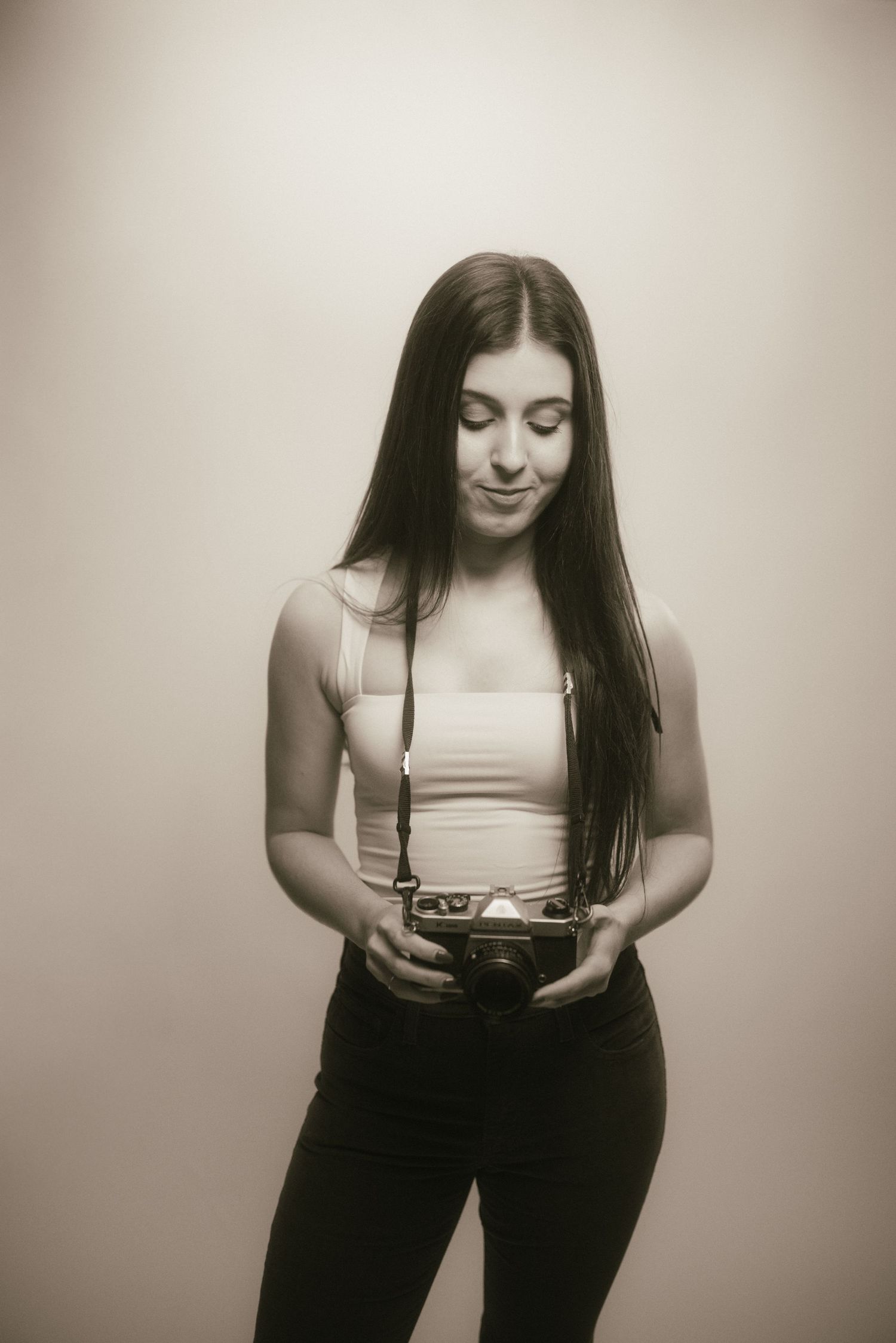 Series of black and white portraits showing artistic poses with vintage camera.