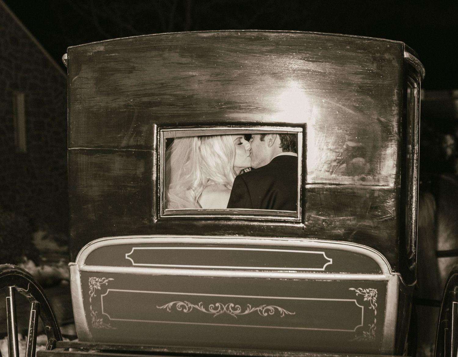 Vintage wooden carriage details shown in dramatic black and white lighting.