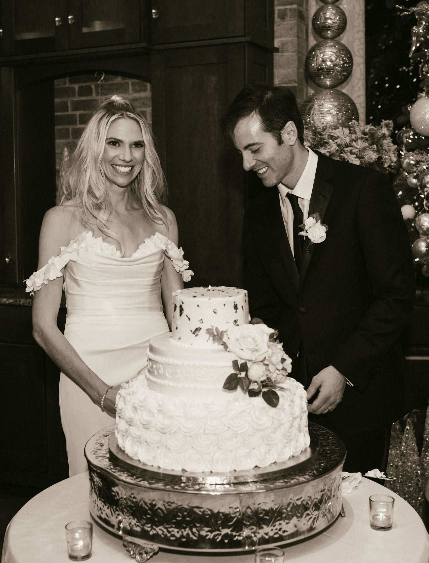 Black and white photos of wedding cake cutting sequence at an elegant reception.