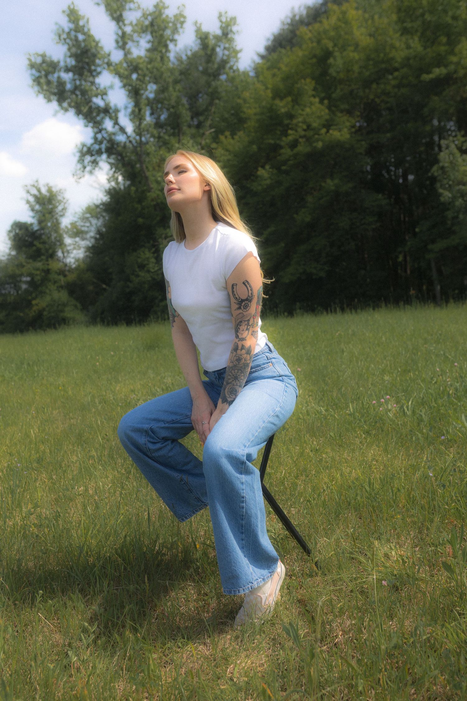 Candid outdoor photography showing someone resting in wildflowers and grass.