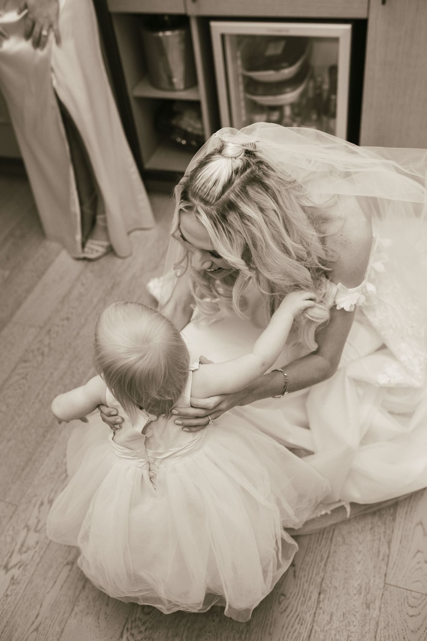 Black and white candid moments captured during wedding day preparations.