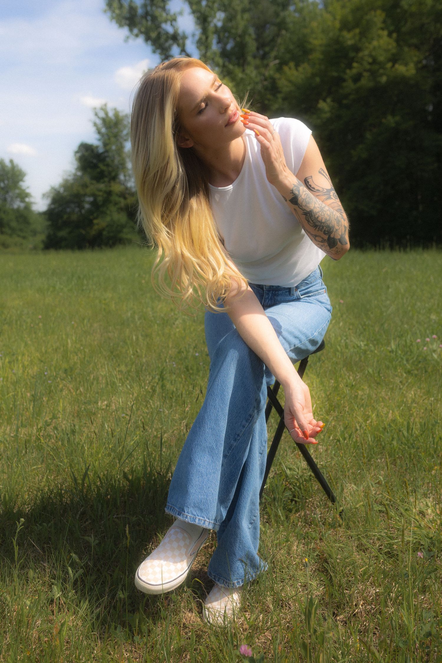 Casual outdoor photoshoot featuring relaxed poses in a natural setting.