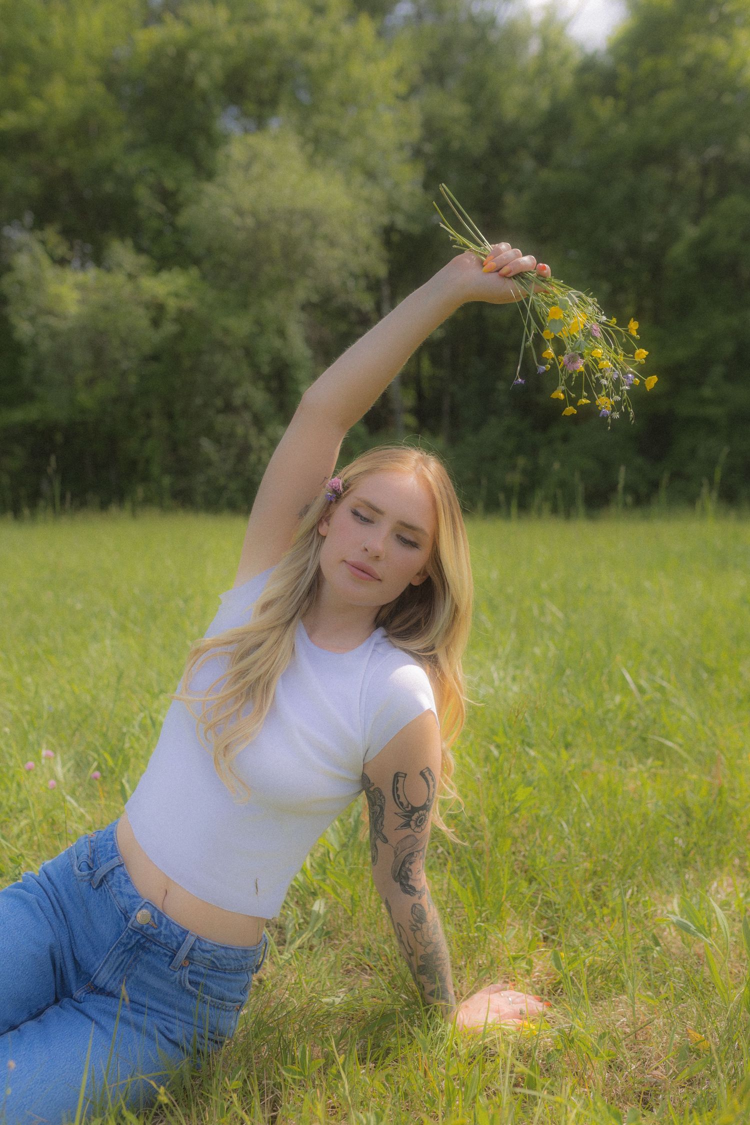 Dreamy outdoor portrait session with wildflowers in a sunny field.