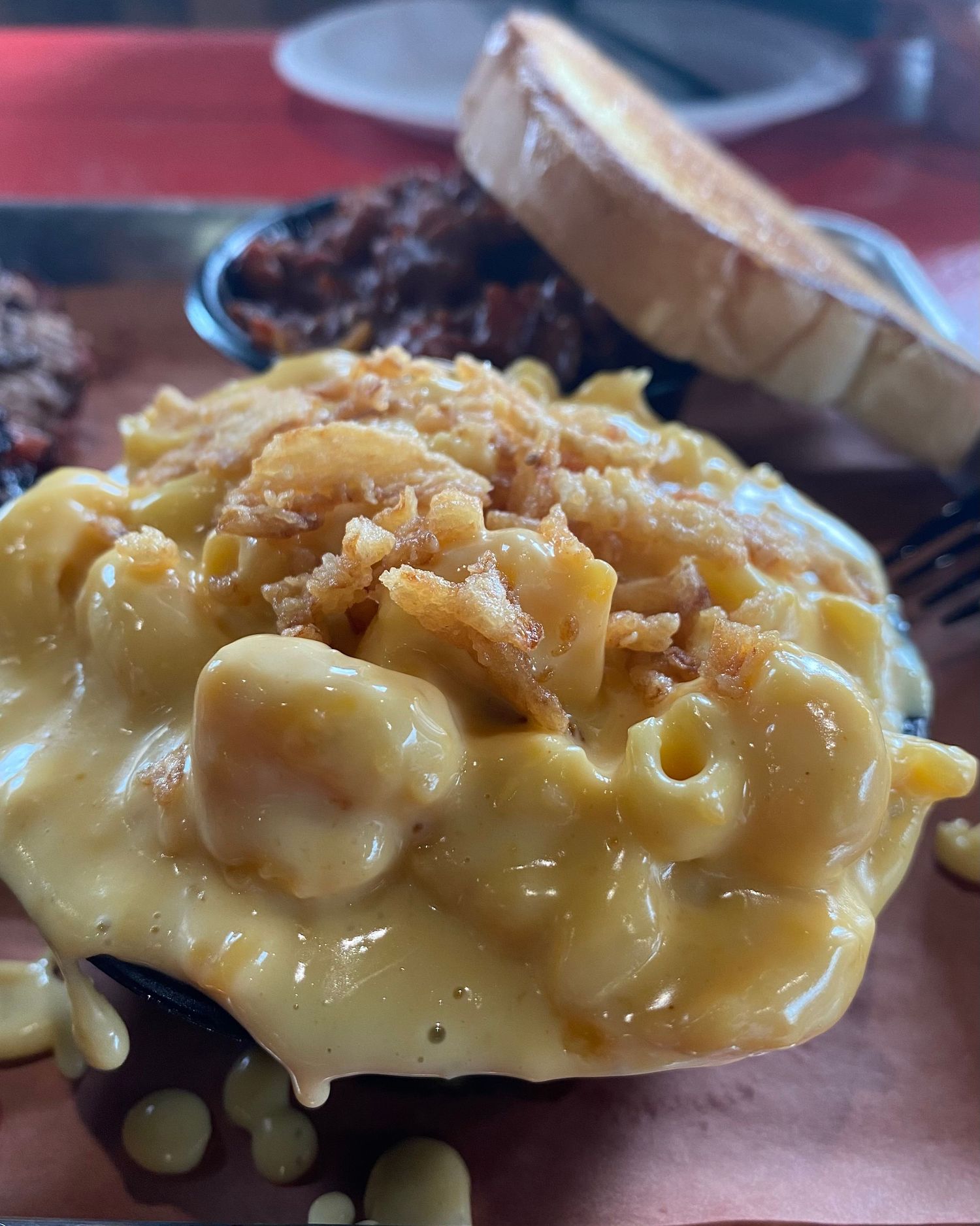Creamy mac and cheese with caramelized onions in extreme close-up detail.