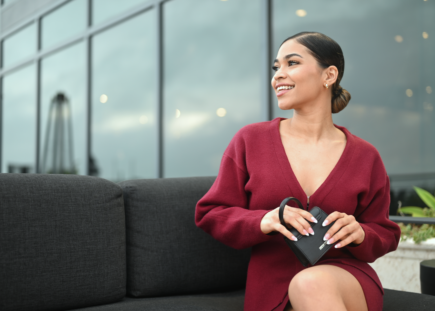 Modern office photoshoot featuring burgundy clothing and glass architecture.