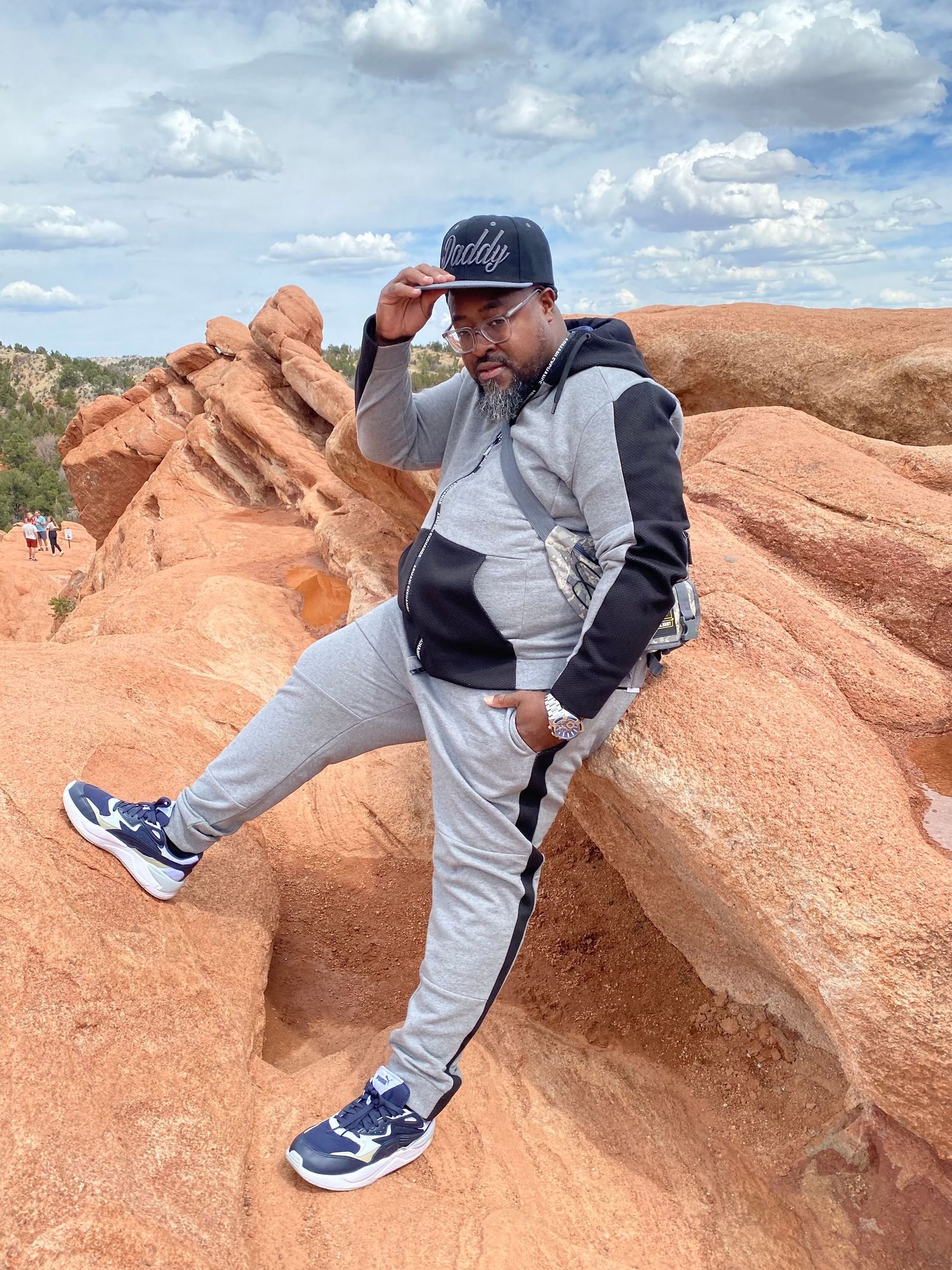 Athletic poses captured against dramatic red rock formations in desert landscape.