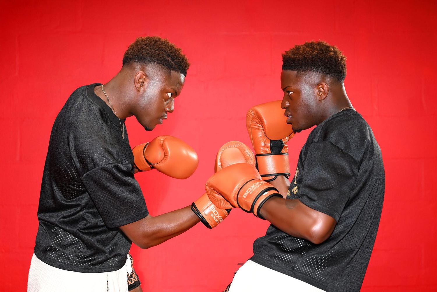 Dynamic boxing match sequence captured against vibrant red background.
