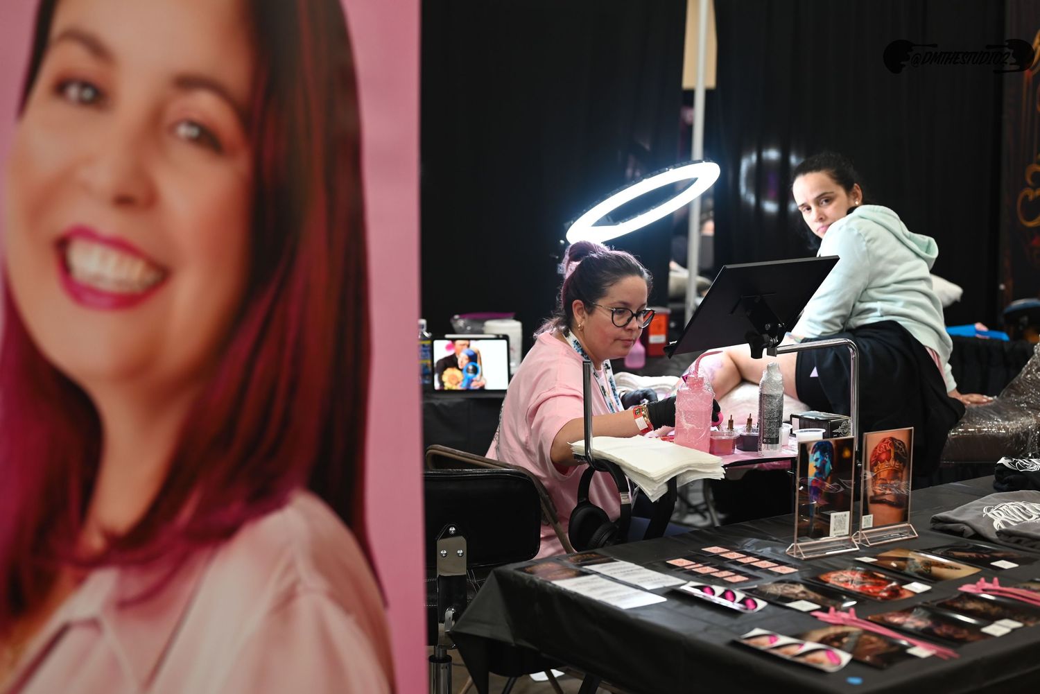 Series of shots showing tattoo artists focused on their detailed work at convention booths.