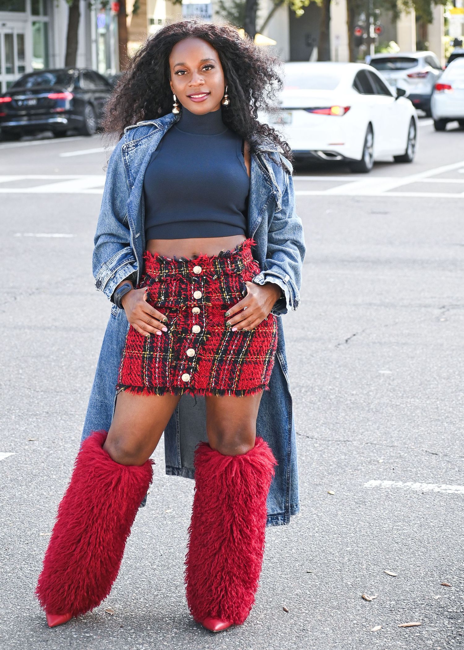 Urban fashion look featuring denim coat, crop top, red skirt and furry red boots.