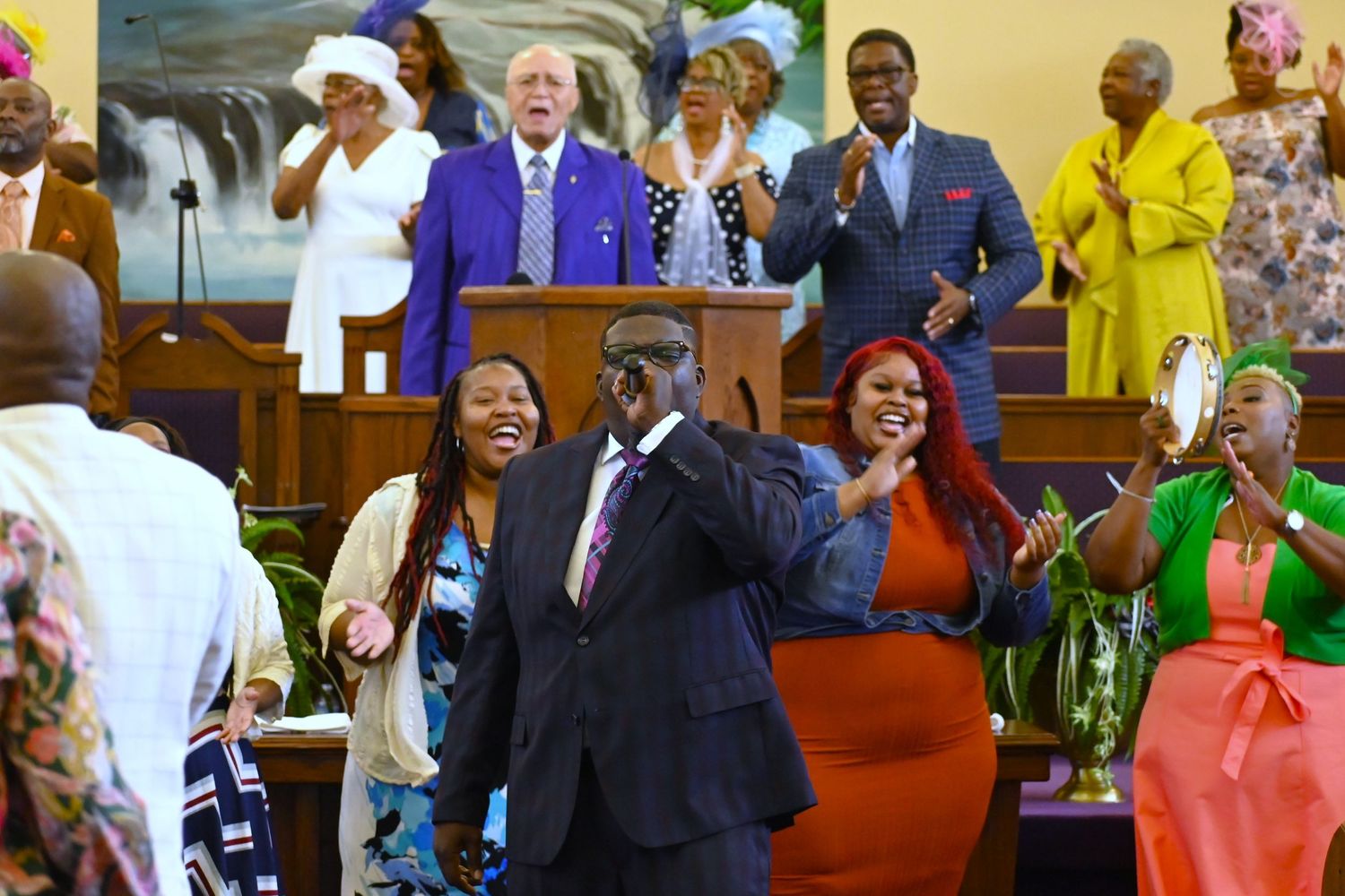 A lively church congregation celebrating during a service with colorful decorations.
