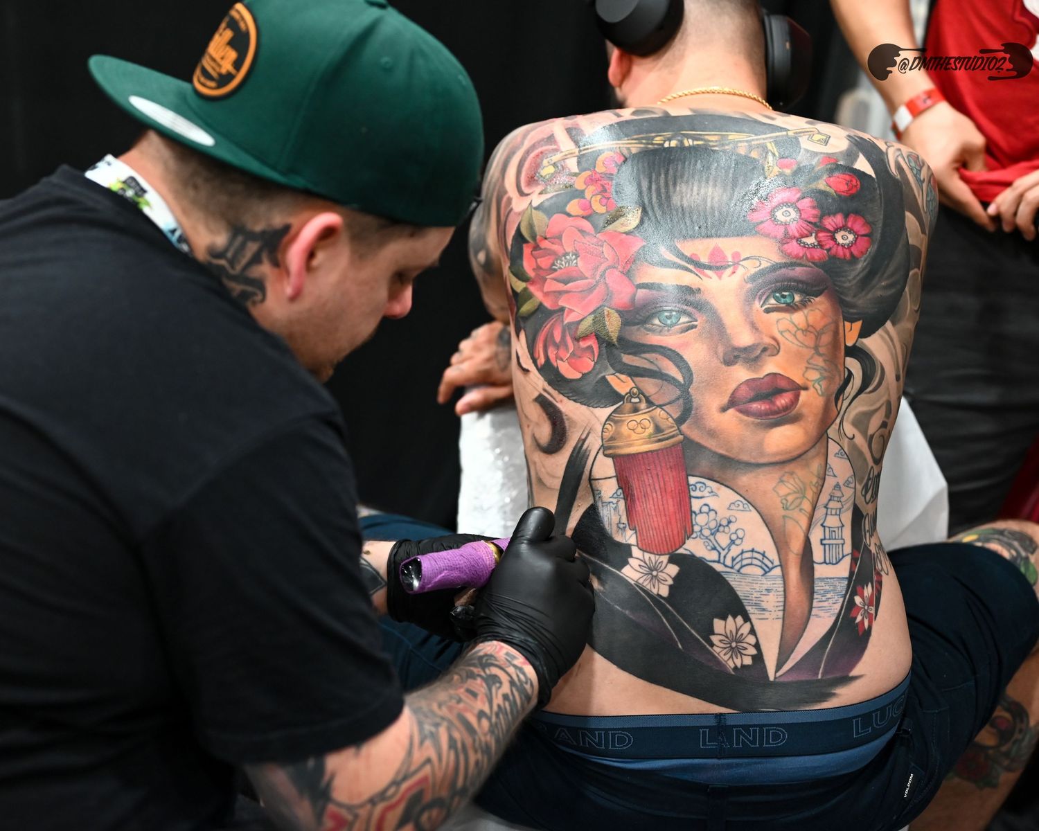 Close-up of intricate tattoo artwork on person's back.