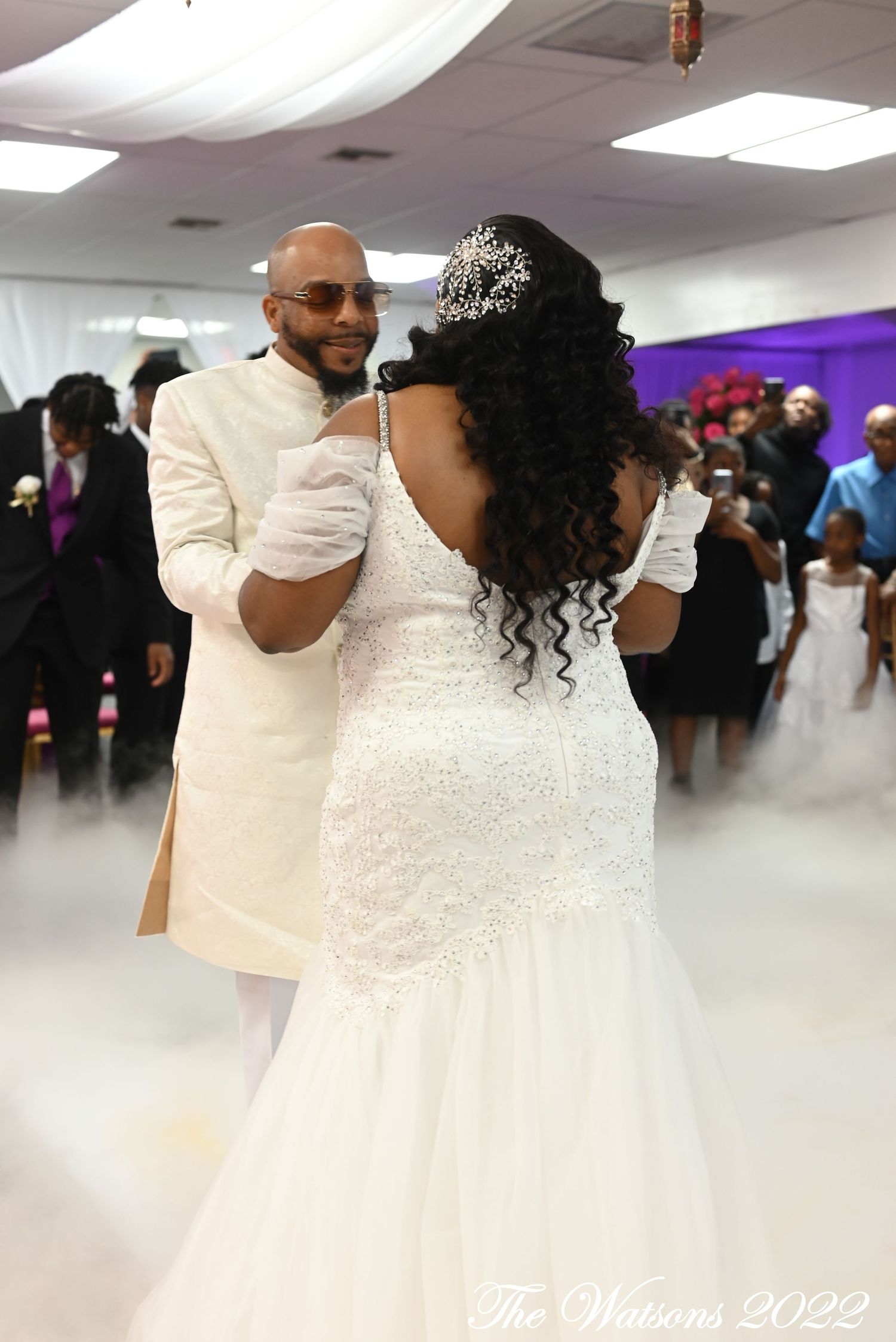 Affordable Tampa wedding photographer captures Bride and groom as they share their first dance surrounded by fog at a wedding reception.