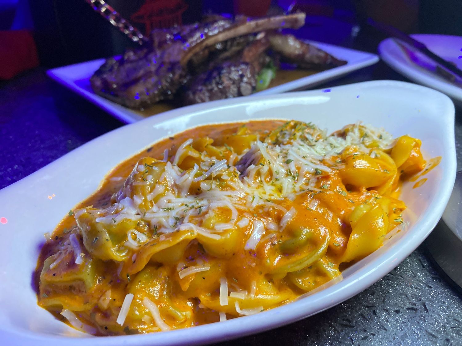 Creamy tortellini pasta in orange vodka sauce topped with grated parmesan cheese.