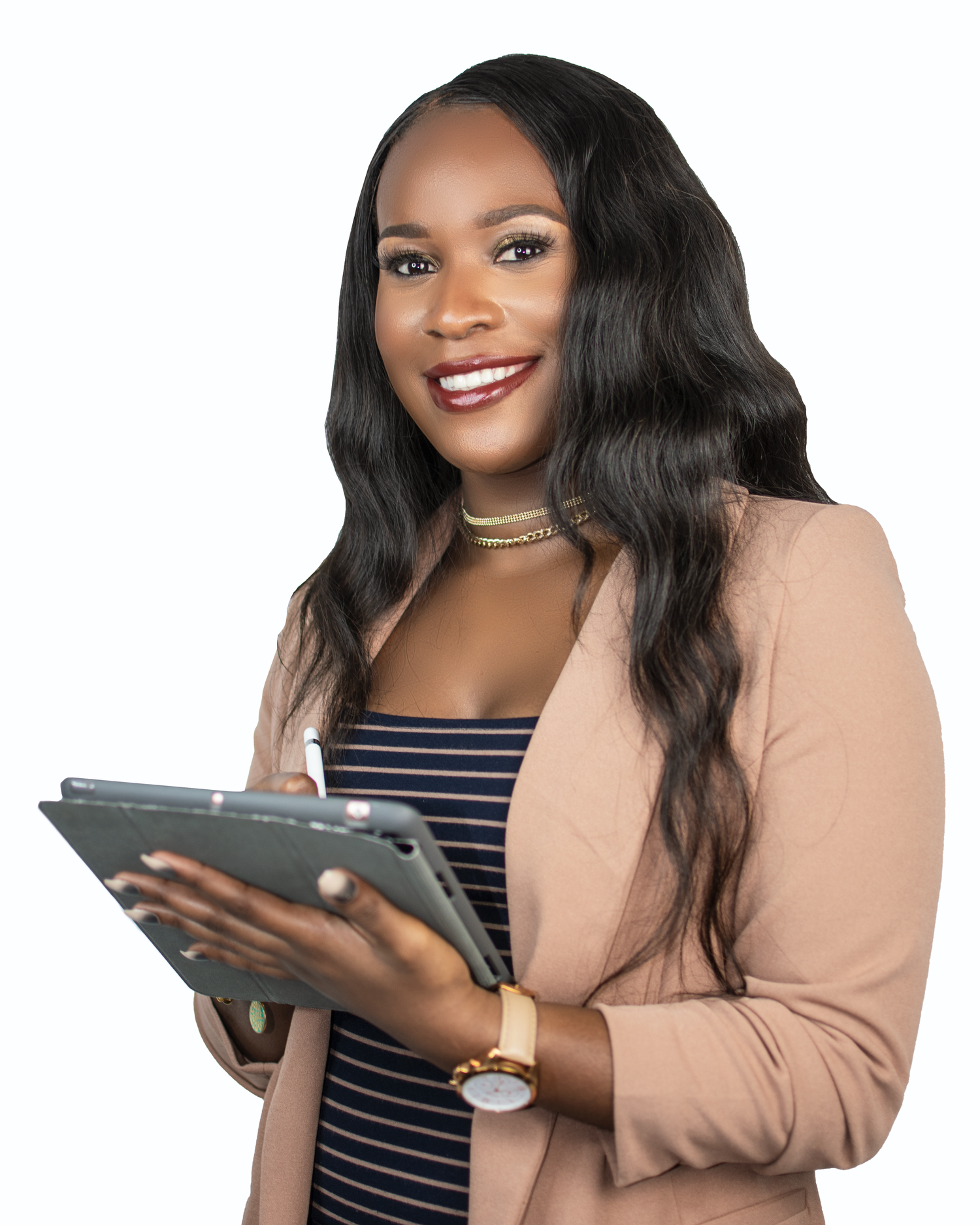 Business professional in peach blazer and striped dress holds tablet device while smiling.