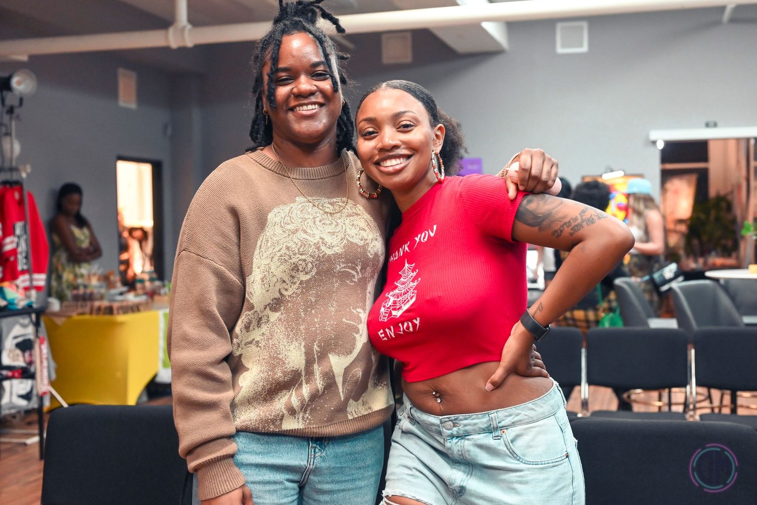 Dancers performing together in casual outfits at indoor community event.