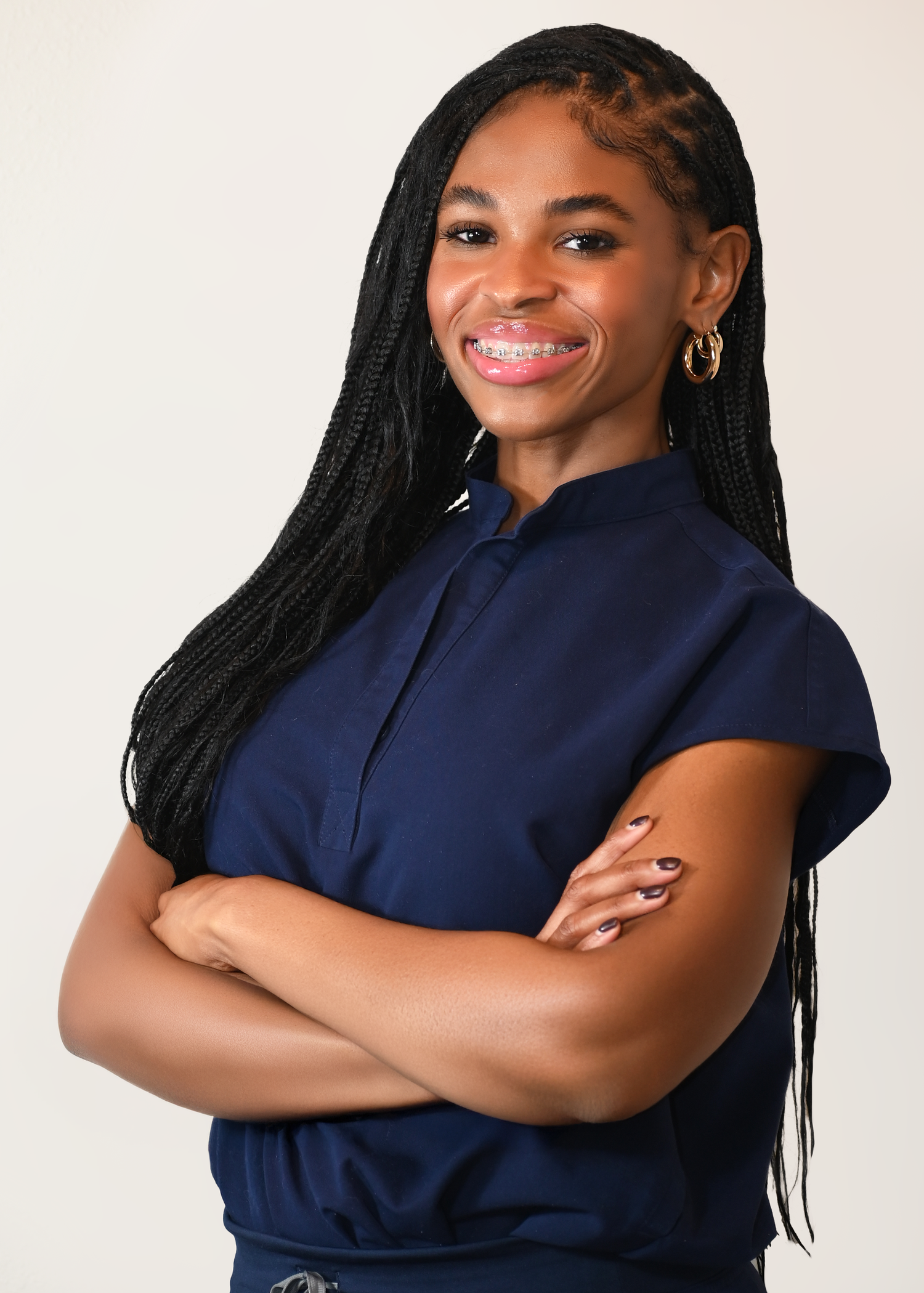 Professional headshots with braided hair and navy collared shirt.