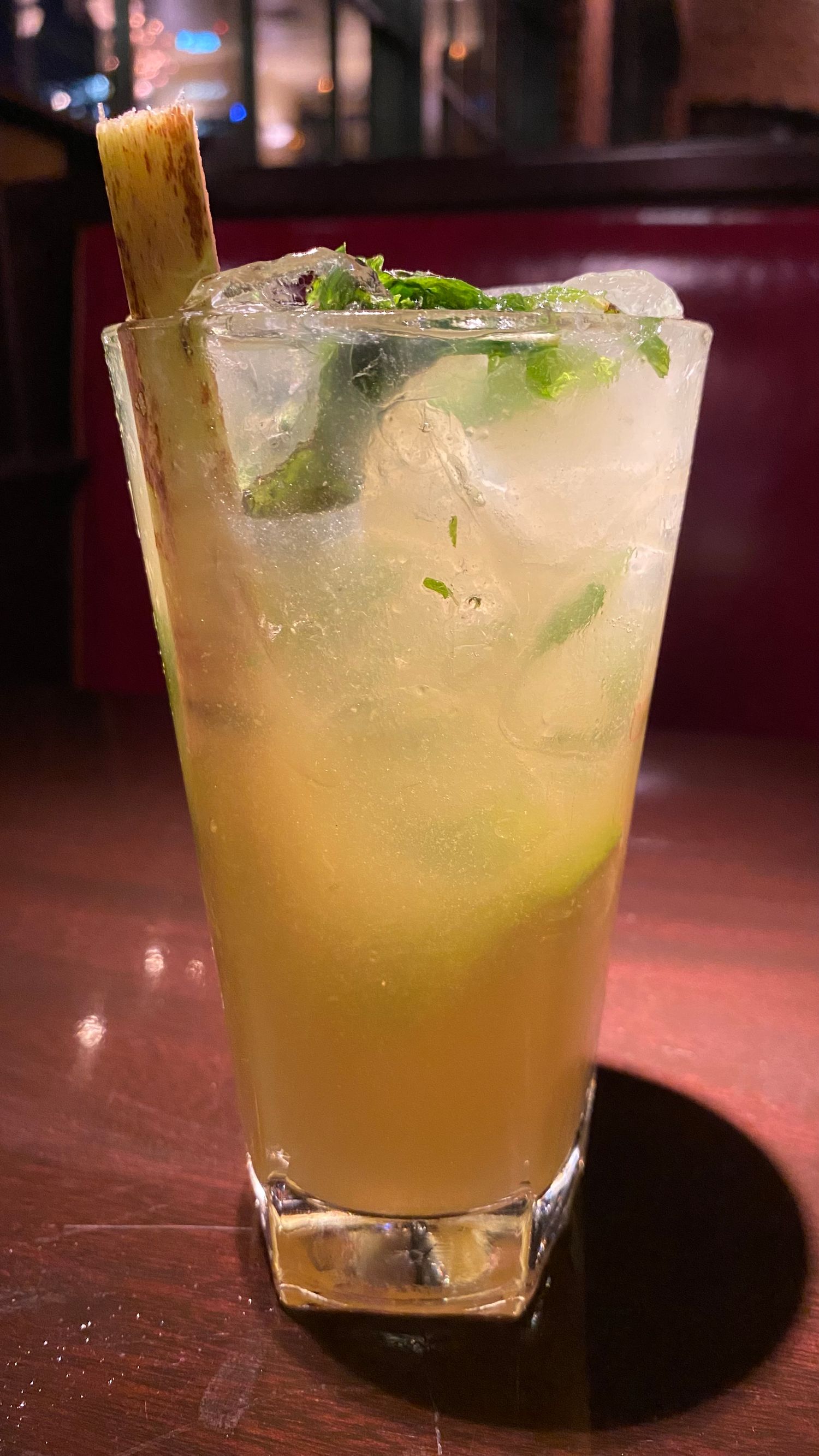 Refreshing citrus cocktail with ice and herbs in a rocks glass.