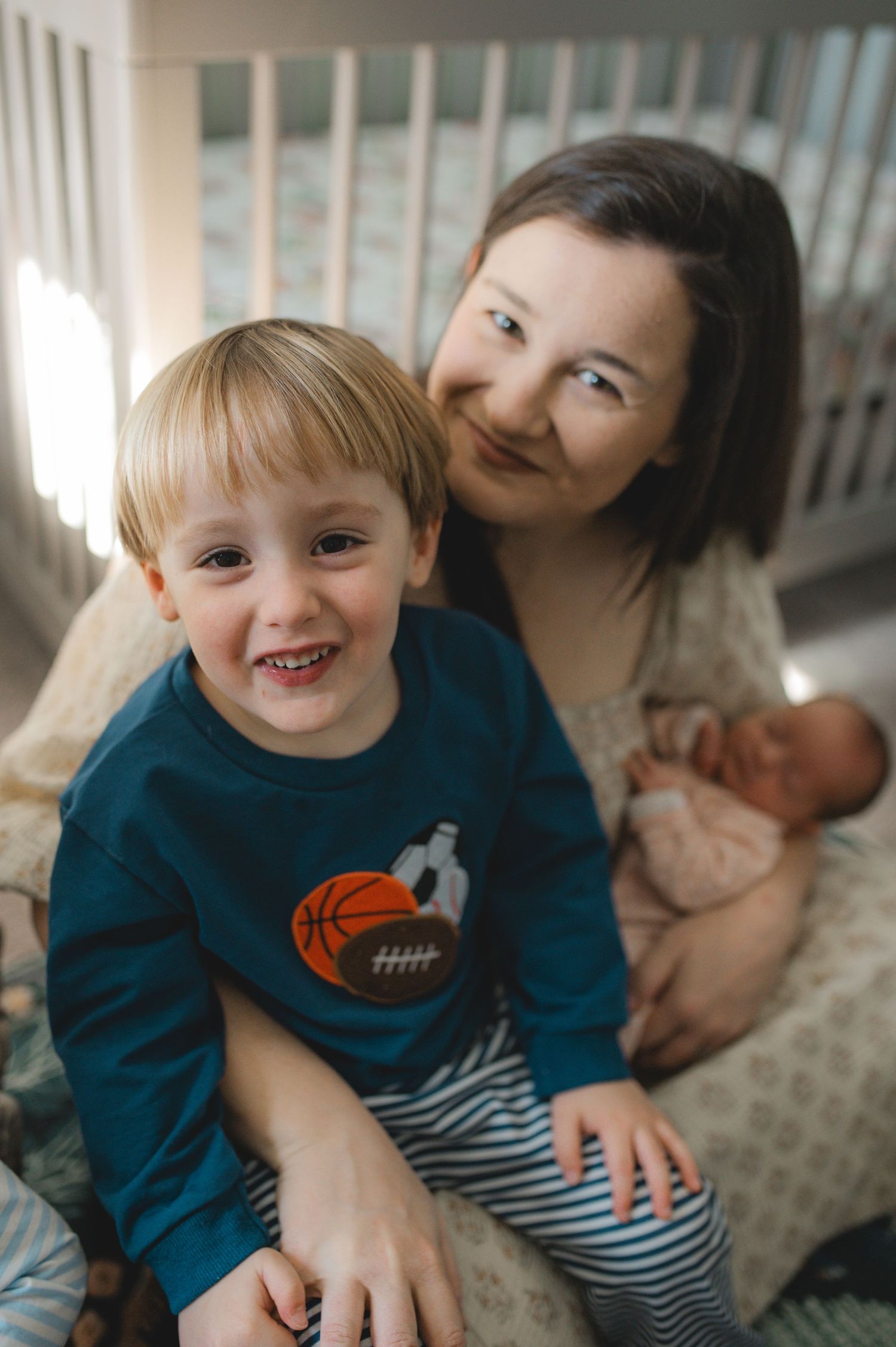 mom, baby and brother child, sitting on floor looking at camera, greenville nc newborn photographer