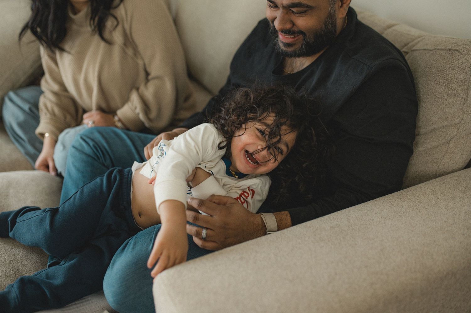 mom dad son, playing on couch with cushions, family at home family photography session, documentary family session