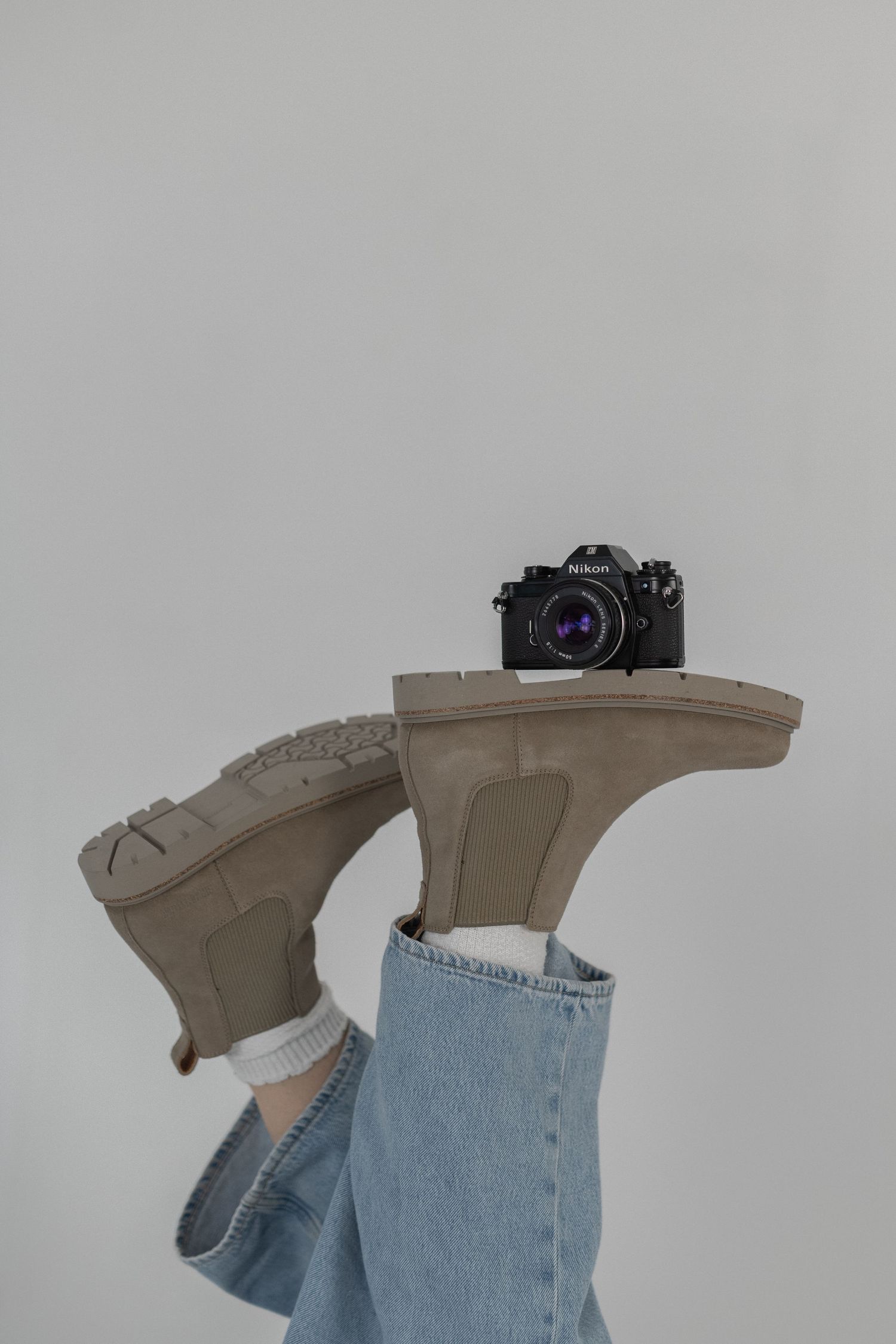 birkenstock highwood slip-on boots women, jeans, white socks, nikon EM film camera