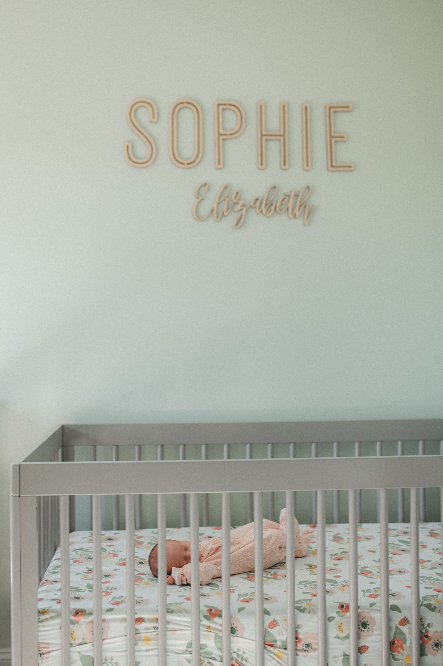 newborn baby girl laying in crib