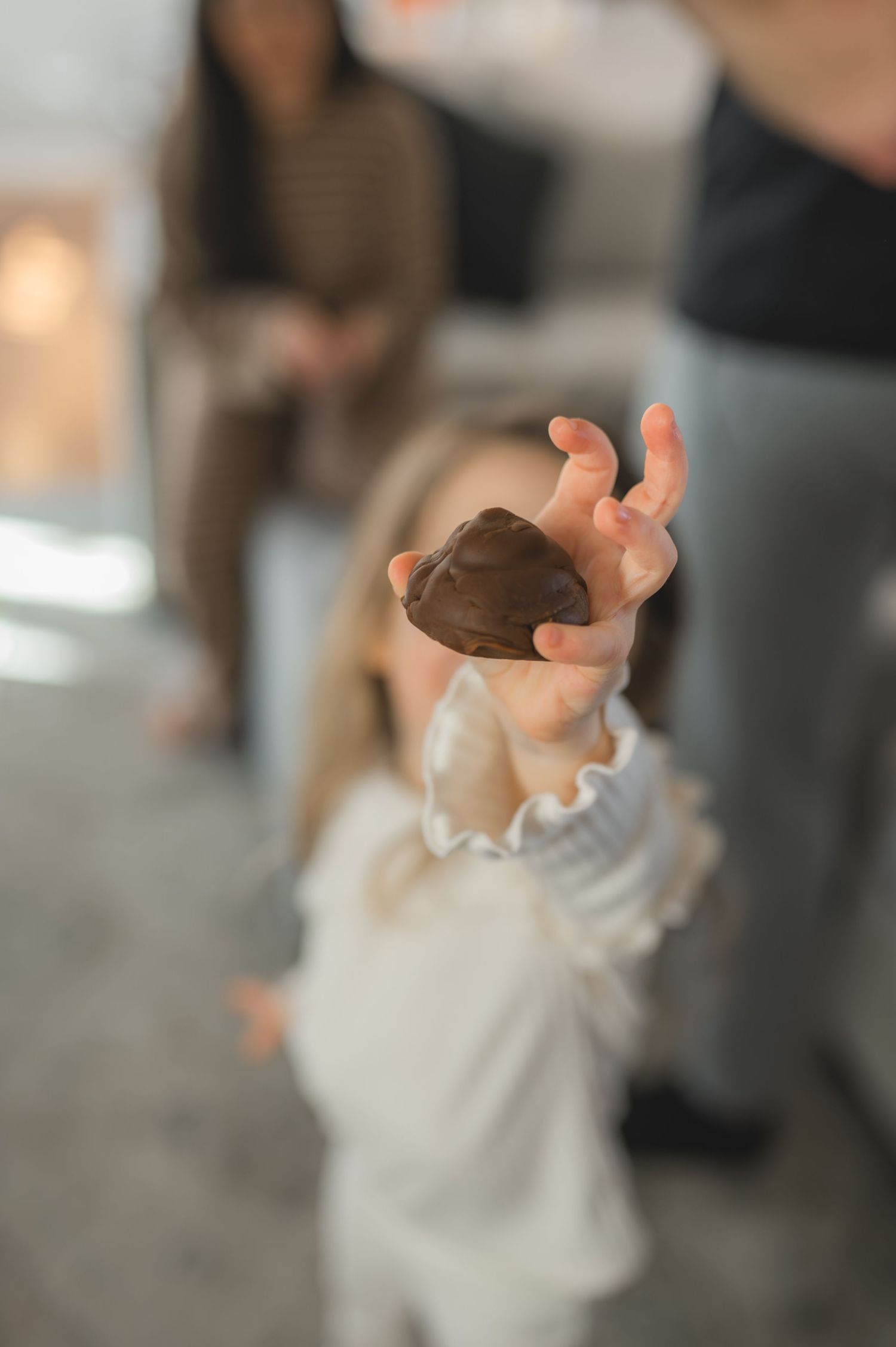 holding play dough to camera, greenville, nc