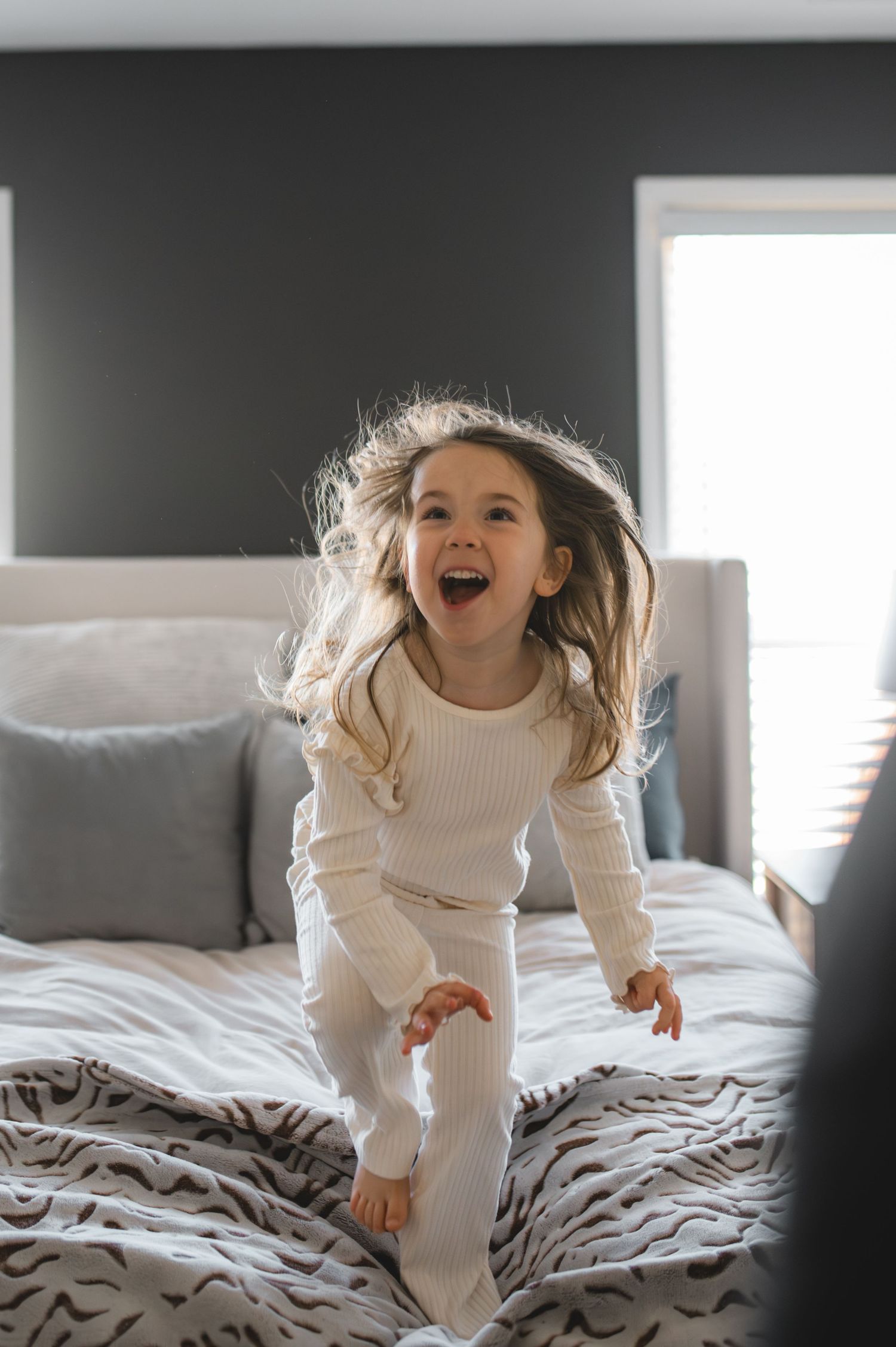 child jumping on bed, greenville, nc