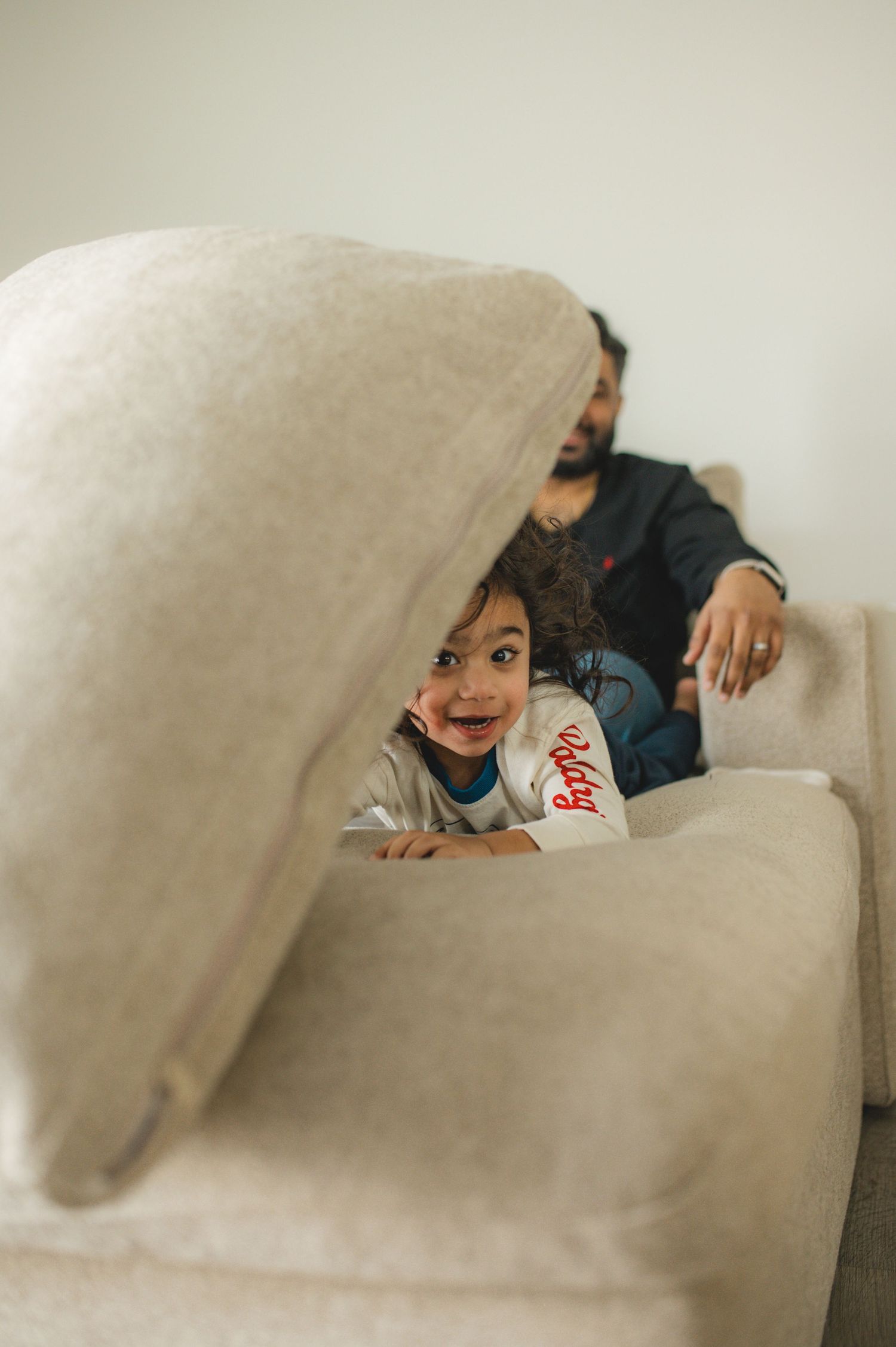 mom dad son, playing on couch with cushions, family at home family photography session, documentary family session