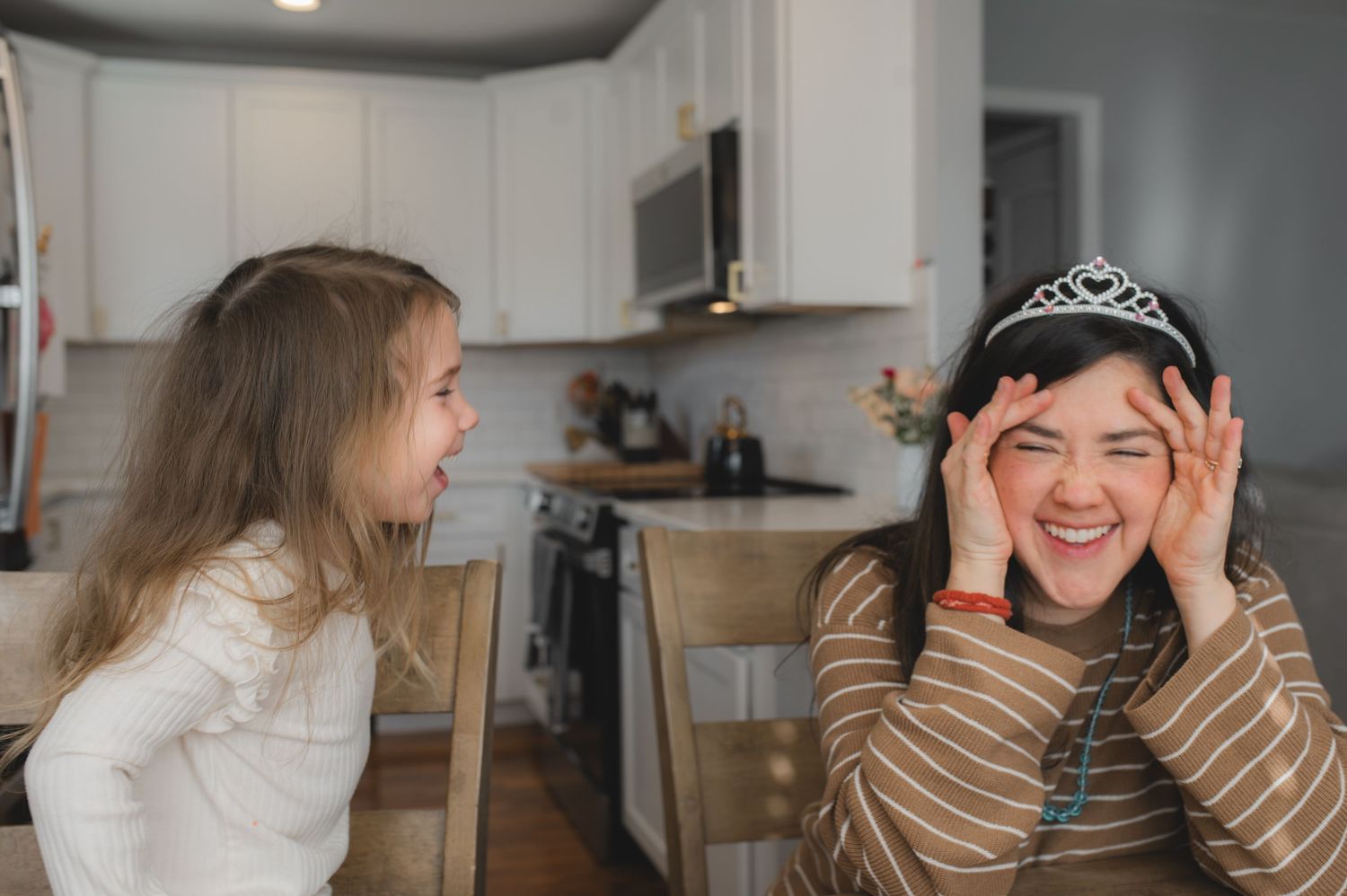 mom and child wearing tiara for board game, laughing, greenville, nc