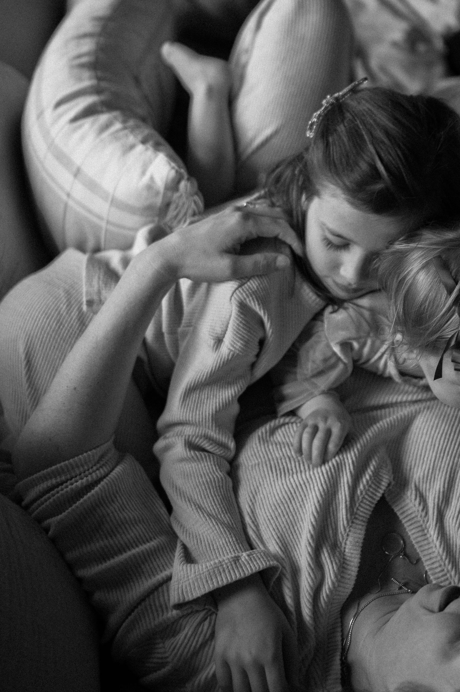 children playing running climbing on bed in parents bedroom, at-home documentary family session mom dad laughing