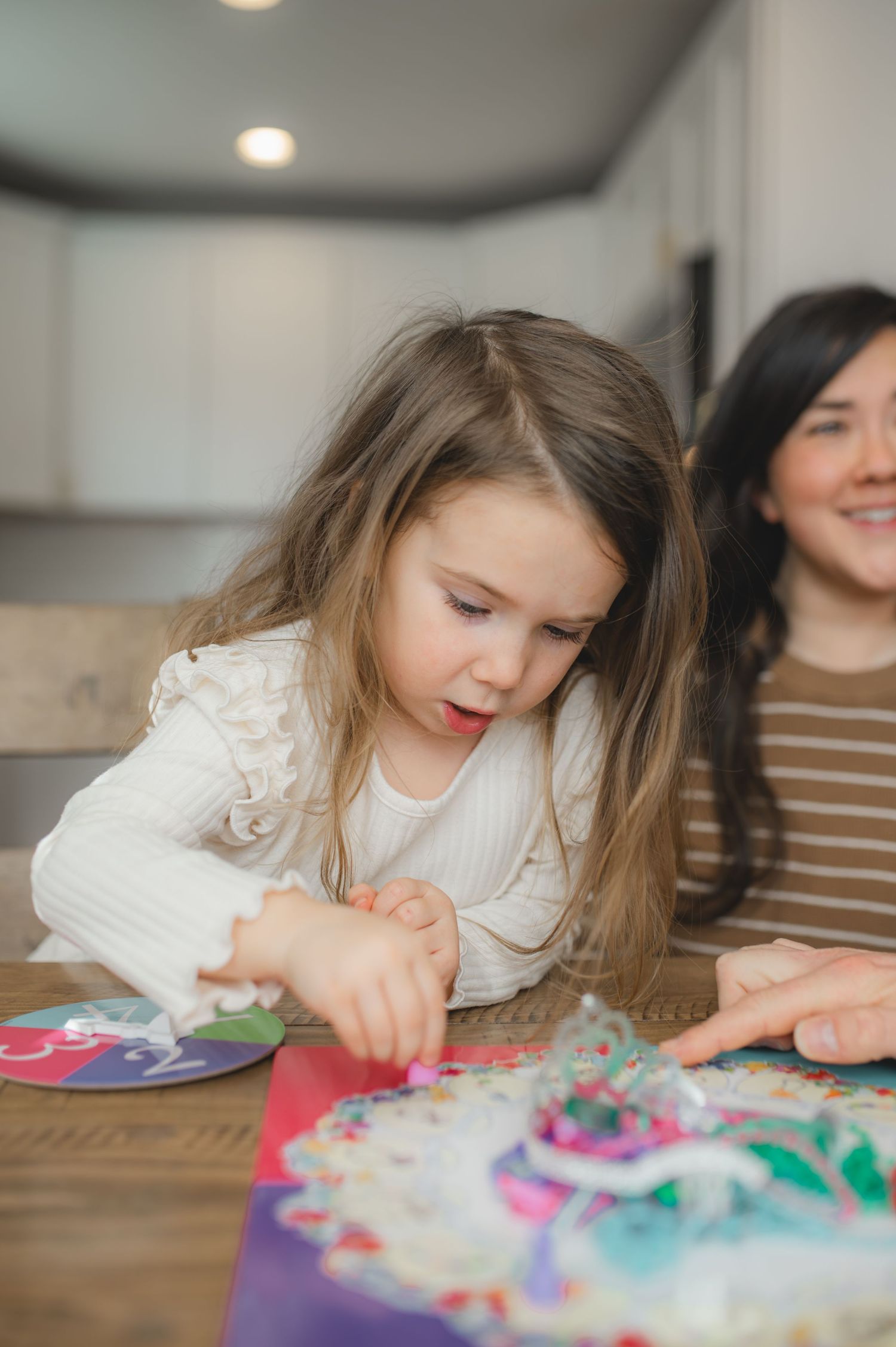 mom and child playing board game, greenville, nc