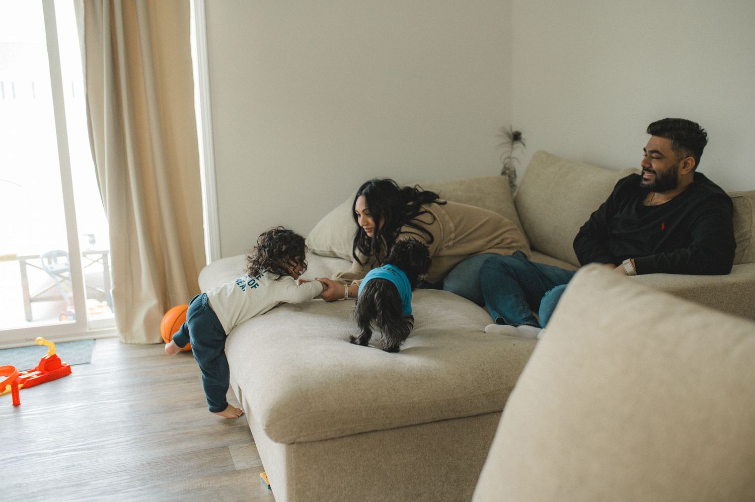 mom dad son, playing on couch, dog standing, toys, family at home family photography session, documentary family session