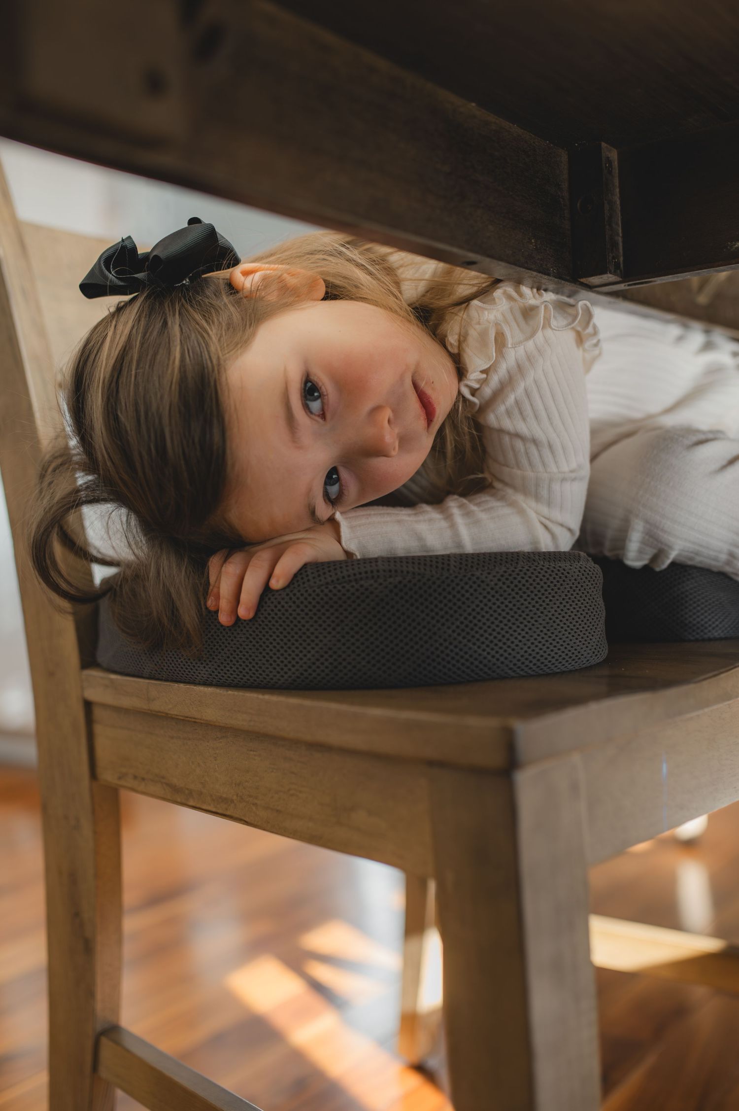 little girl looking at camera under the table, greenville, nc