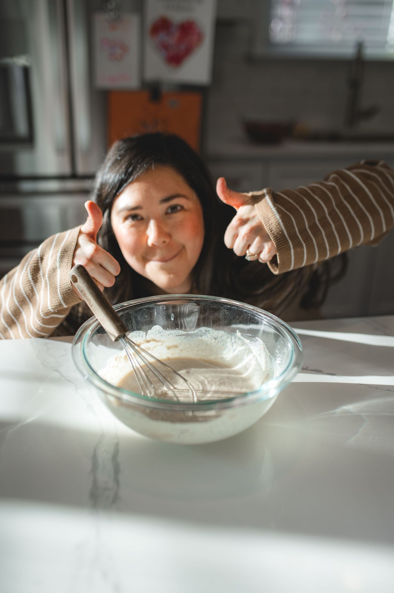 mom posing with two thumbs up behind pancake batter bowl, greenville, nc