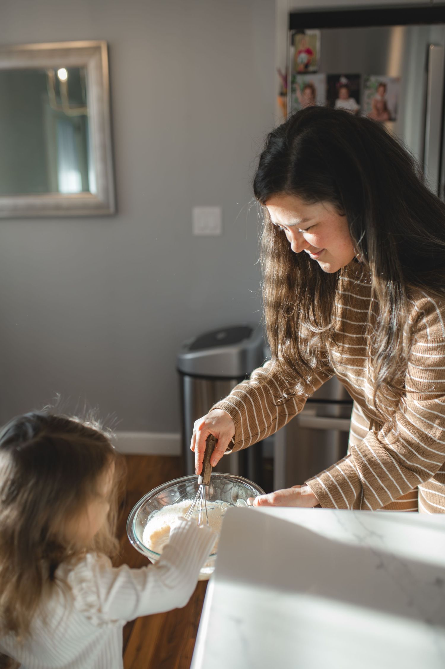 mom and daughter mixing pancakes batter in glass bowl, greenville, nc