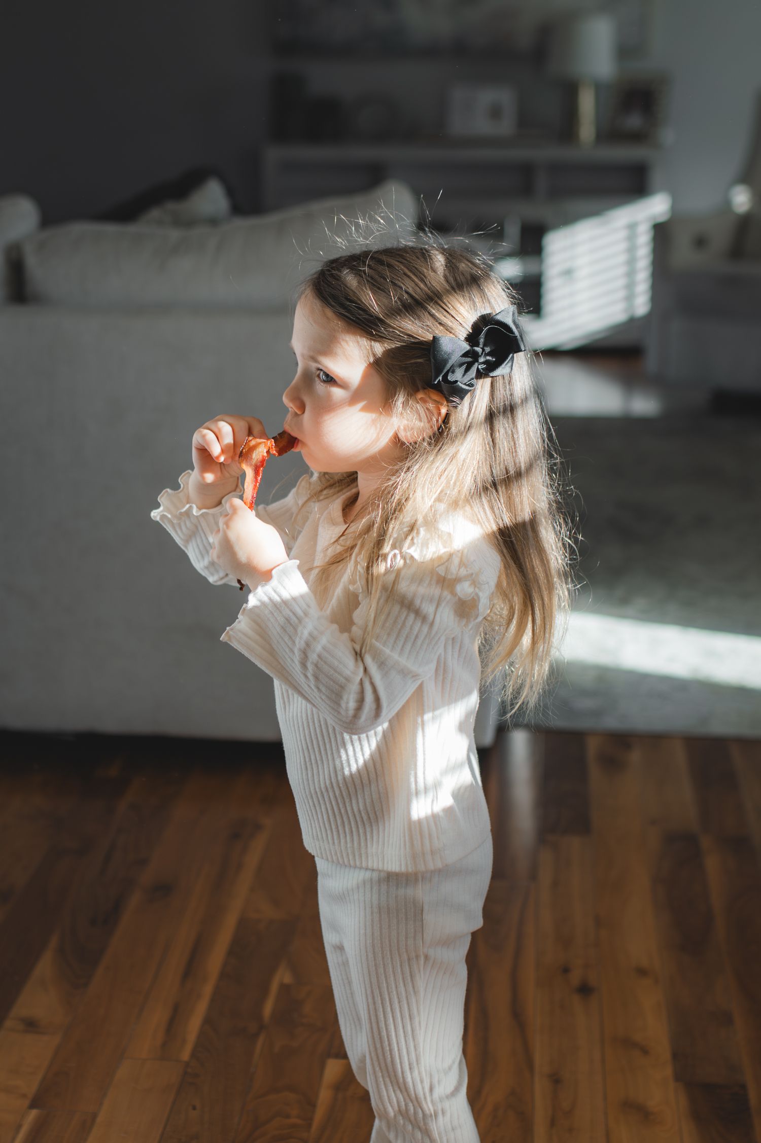 little girl eating a slice of bacon, greenville, nc