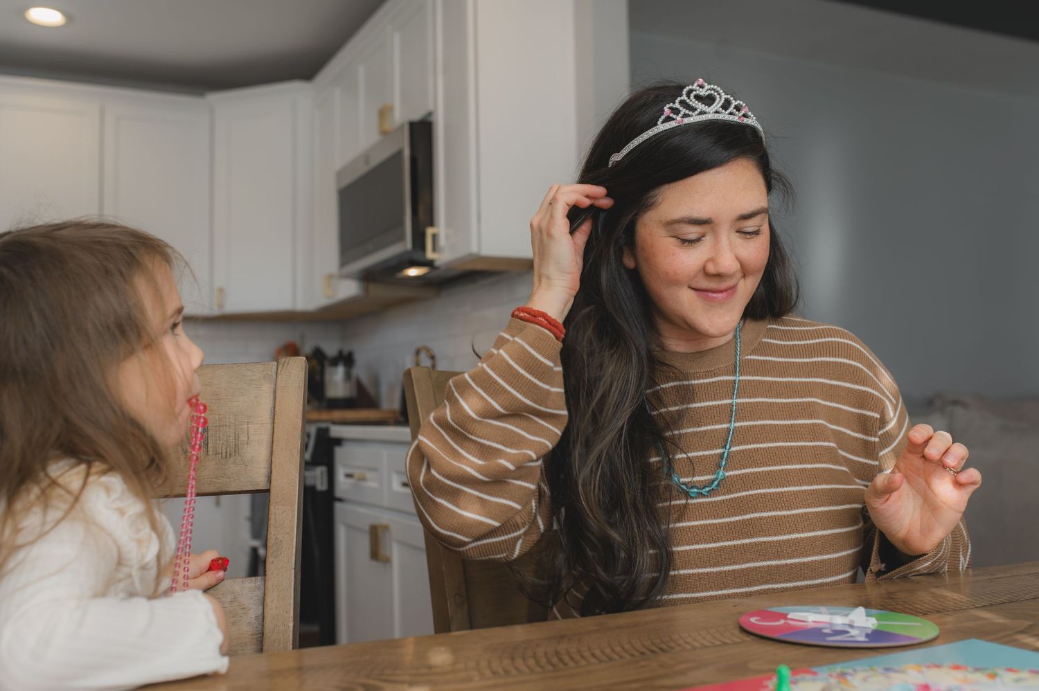 mom wearing tiara for board game, greenville, nc