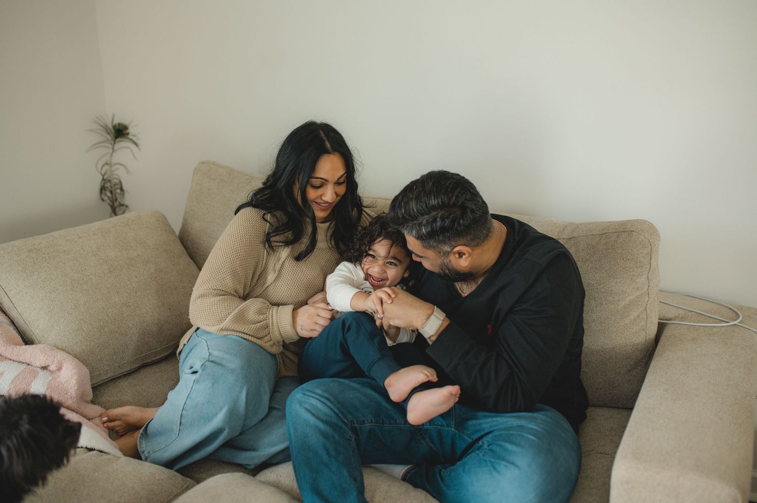 mom dad son, playing on couch with cushions, family at home family photography session, documentary family session