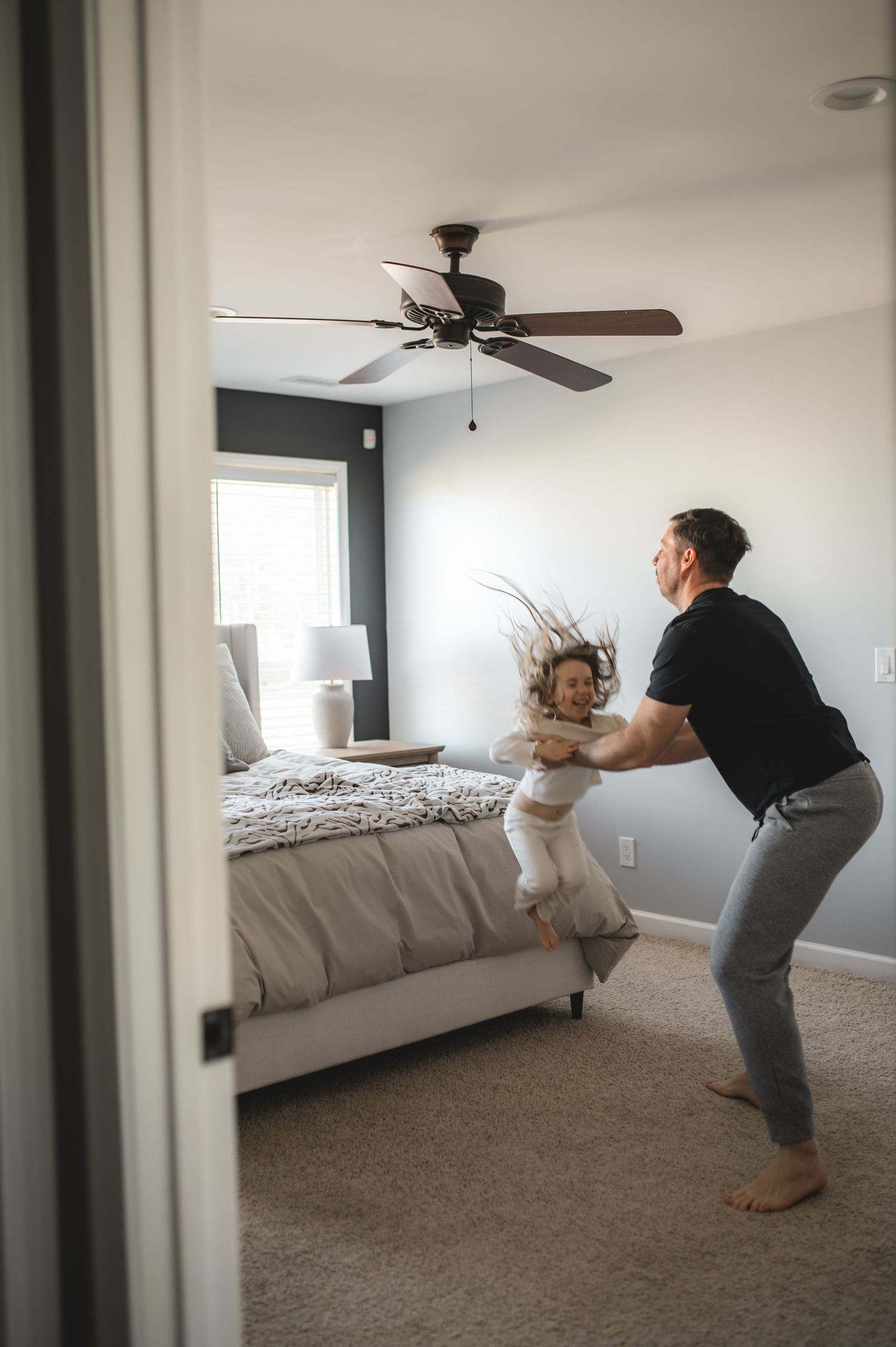 child and dad jumping on bed,greenville, nc