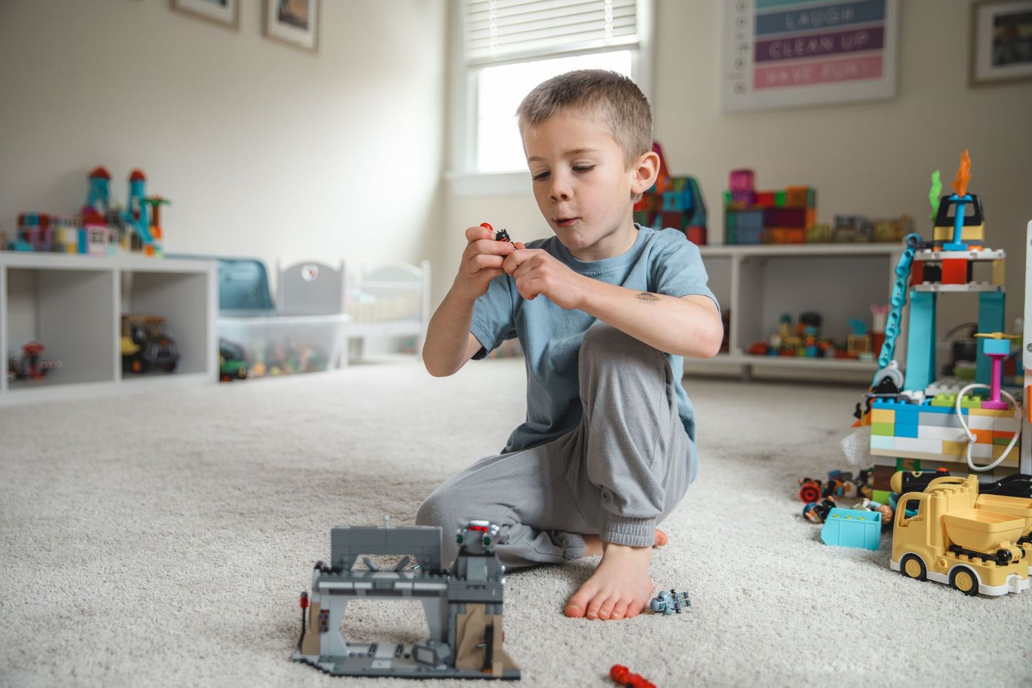 child playing with legos in playroom on the floor