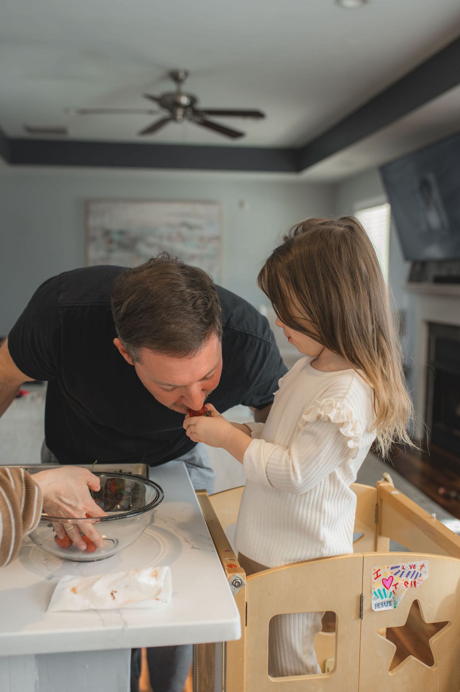 dad and child with baking tray and bowl of strawberries and chocolate, greenville, nc
