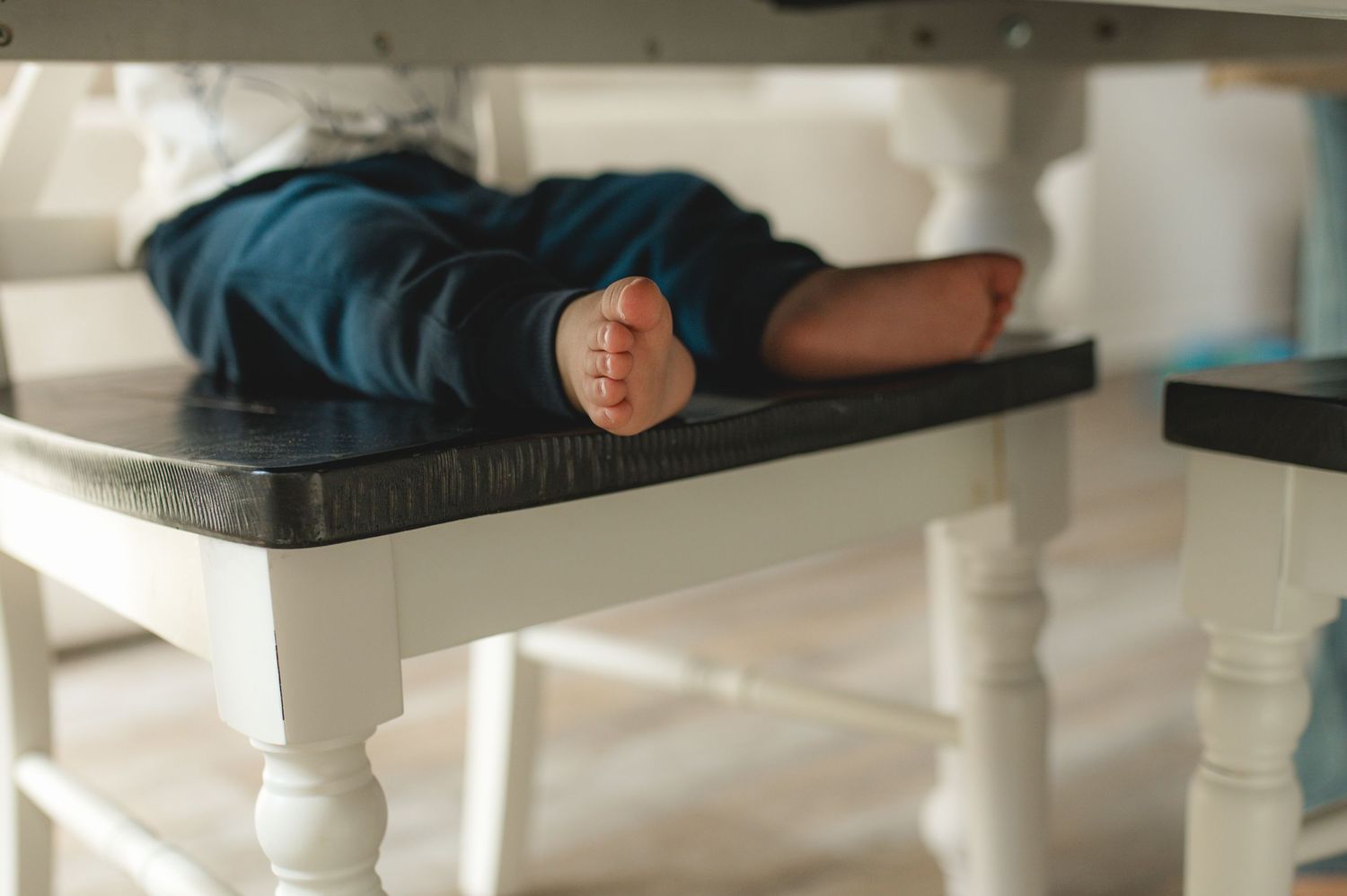 childs feet at table eating a snack