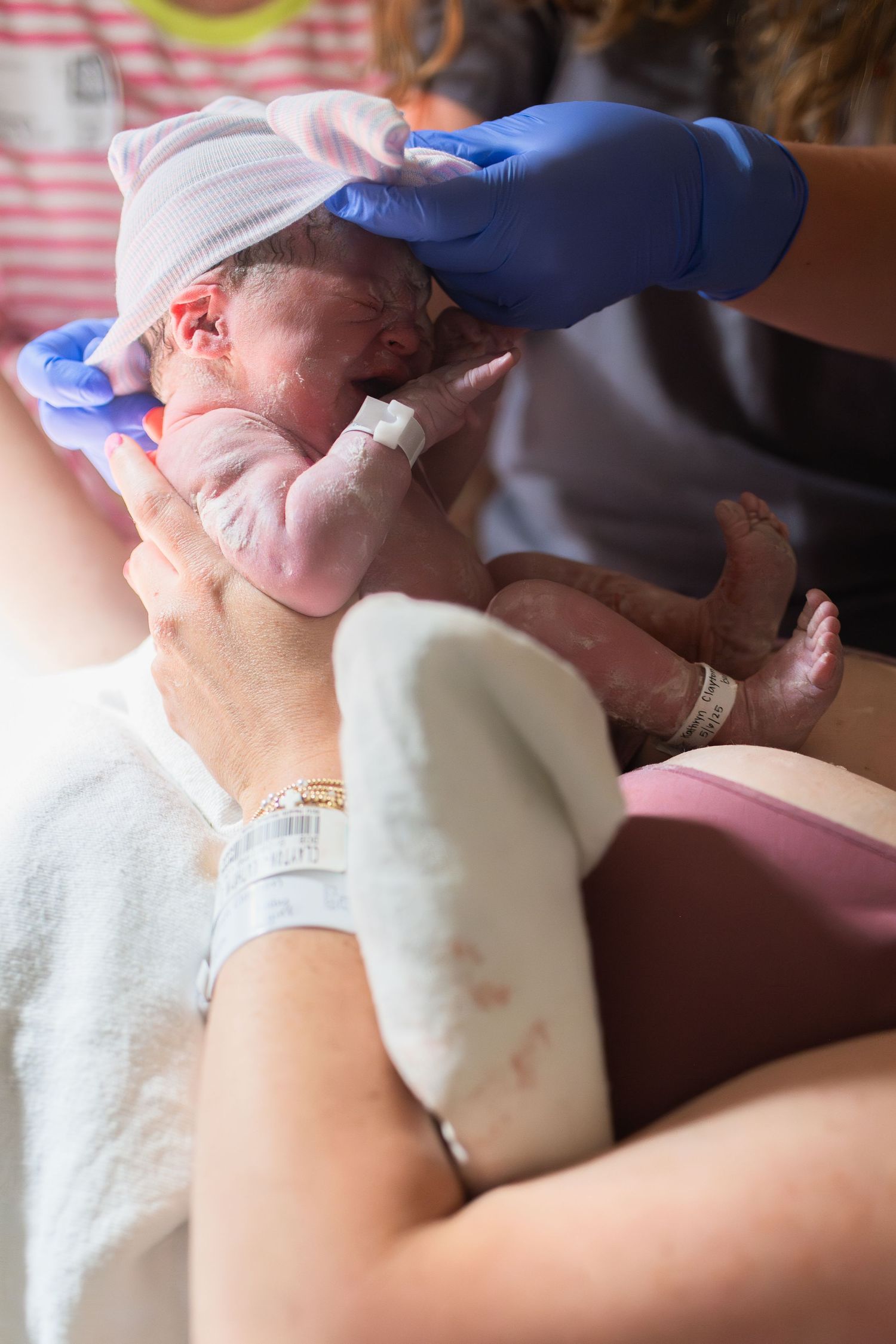 baby after birth baby on mothers chest crying laughing smiling hugging. ECU Health Medical Center in Greenville NC birth photographer