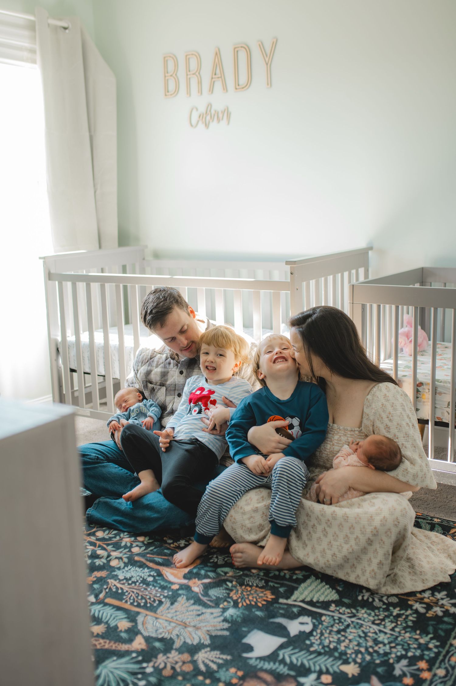 family sitting in nursery in front of crib, newborn twins, 3 year old twins, 4 under 4, big brother, little sister, little brother
