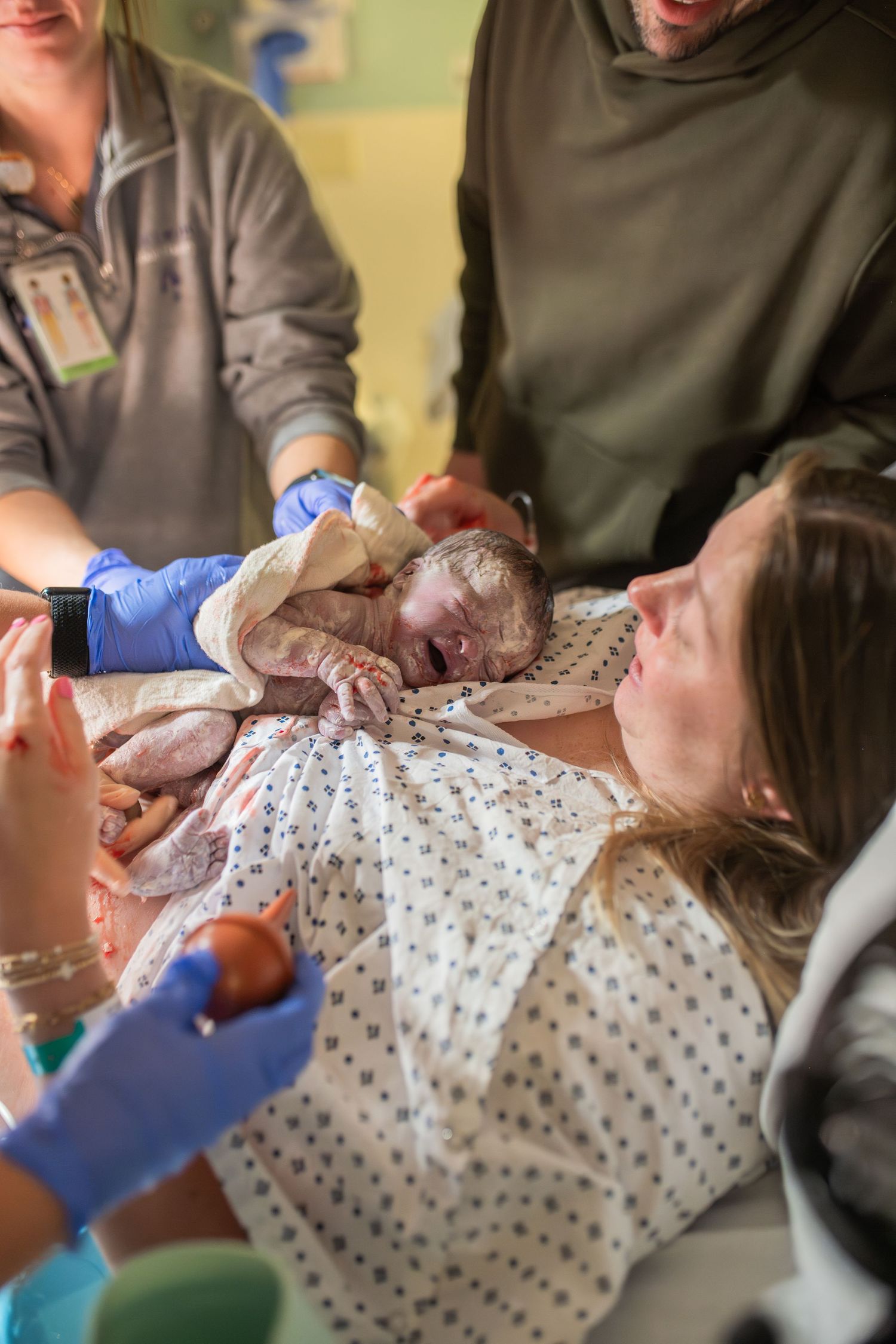 mom looking at baby after birth at ECU Health Medical Center in Greenville NC. baby on mothers chest. birth photographer