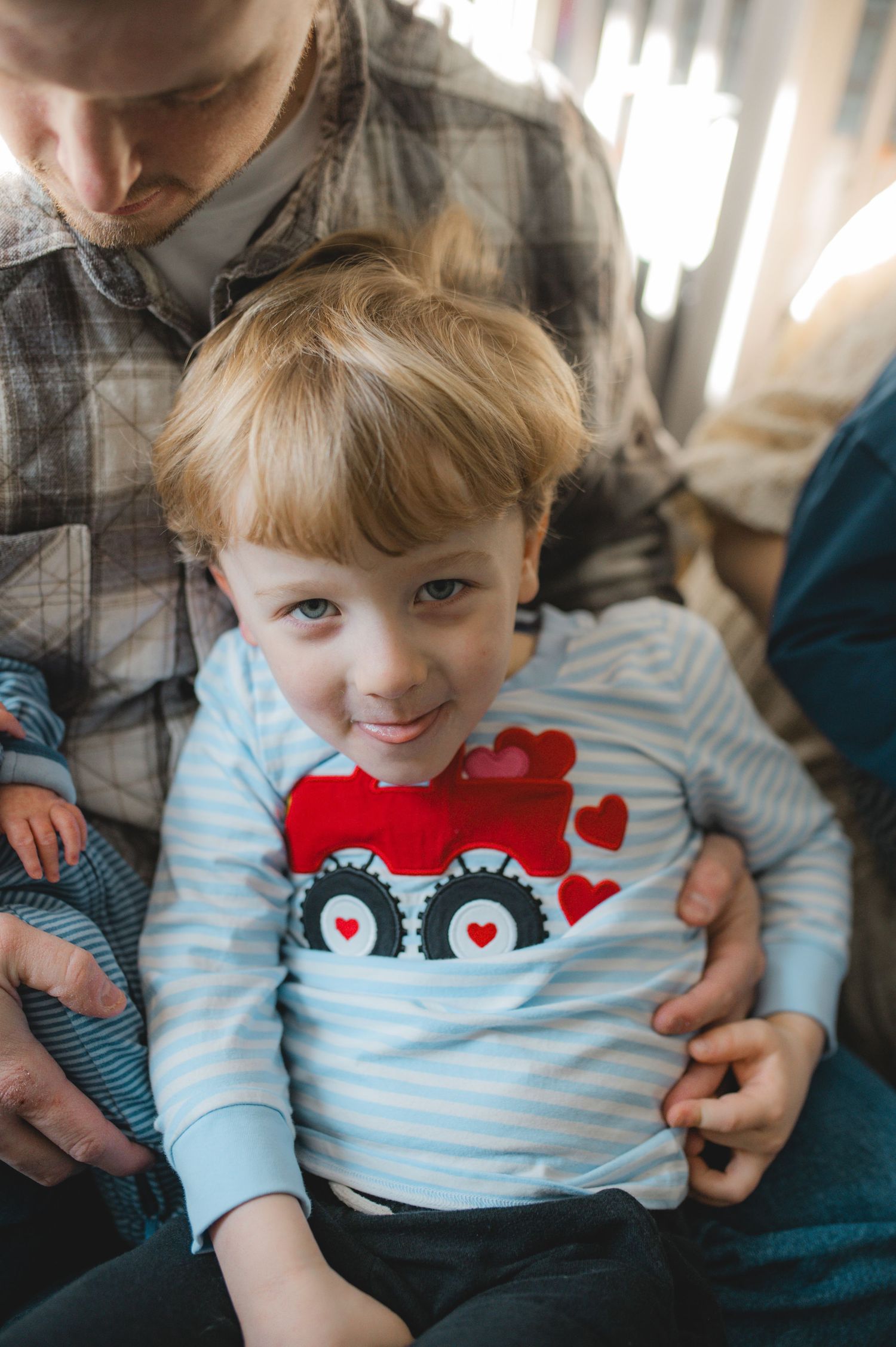 mom, baby and brother child, sitting on floor looking at camera, greenville nc newborn photographer